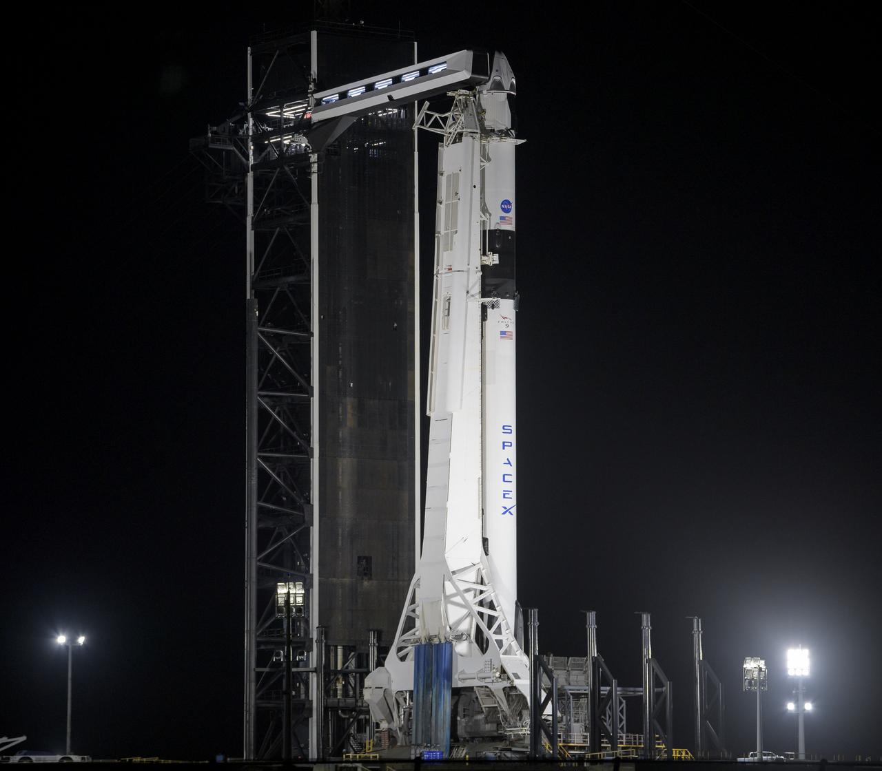A SpaceX Falcon 9 rocket with the company's Crew Dragon spacecraft onboard is seen on the launch pad at Launch Complex 39A as preparations continue for the Demo-2 mission, Friday, May 29, 2020, at NASA’s Kennedy Space Center in Florida. NASA’s SpaceX Demo-2 mission is the first launch with astronauts of the SpaceX Crew Dragon spacecraft and Falcon 9 rocket to the International Space Station as part of the agency’s Commercial Crew Program. The test flight serves as an end-to-end demonstration of SpaceX’s crew transportation system. Robert Behnken and Douglas Hurley are scheduled to launch at 3:22 p.m. EDT on Saturday, May 30, from Launch Complex 39A at the Kennedy Space Center. A new era of human spaceflight is set to begin as American astronauts once again launch on an American rocket from American soil to low-Earth orbit for the first time since the conclusion of the Space Shuttle Program in 2011. Photo Credit: (NASA/Bill Ingalls)