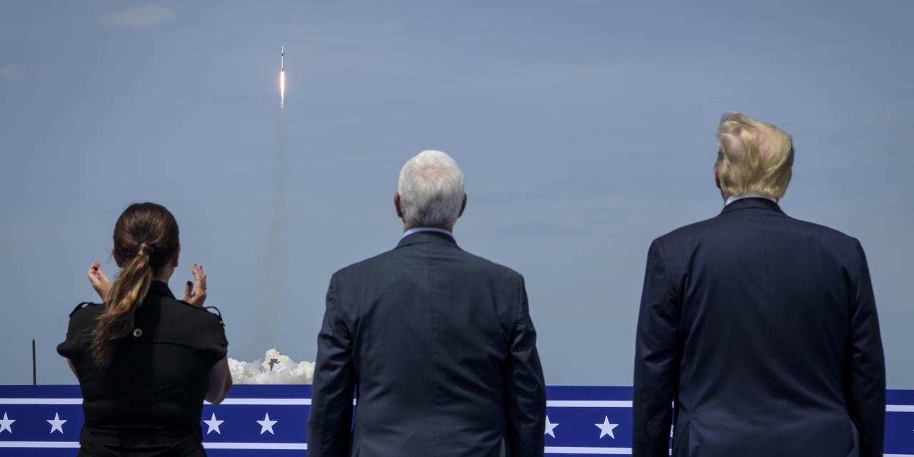 President Donald Trump, right, Vice President Mike Pence, and Second Lady Karen Pence watch the launch of a SpaceX Falcon 9 rocket carrying the company's Crew Dragon spacecraft on NASA’s SpaceX Demo-2 mission with NASA astronauts Robert Behnken and Douglas Hurley onboard, Saturday, May 30, 2020, from the balcony of Operations Support Building II at NASA’s Kennedy Space Center in Florida. NASA’s SpaceX Demo-2 mission is the first launch with astronauts of the SpaceX Crew Dragon spacecraft and Falcon 9 rocket to the International Space Station as part of the agency’s Commercial Crew Program. The test flight serves as an end-to-end demonstration of SpaceX’s crew transportation system. Behnken and Hurley launched at 3:22 p.m. EDT on Saturday, May 30, from Launch Complex 39A at the Kennedy Space Center. A new era of human spaceflight is set to begin as American astronauts once again launch on an American rocket from American soil to low-Earth orbit for the first time since the conclusion of the Space Shuttle Program in 2011. Photo Credit: (NASA/Bill Ingalls)