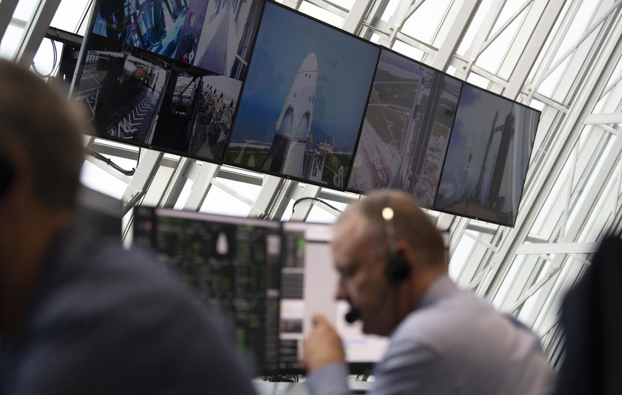 Monitors inside firing room four show views of a SpaceX Falcon 9 rocket carrying the company's Crew Dragon spacecraft on the Demo-2 mission with NASA astronauts Douglas Hurley and Robert Behnken onboard at Launch Complex 39A, Saturday, May 30, 2020, in  firing room four of the Launch Control Center at NASA’s Kennedy Space Center in Florida. NASA’s SpaceX Demo-2 mission is the first launch with astronauts of the SpaceX Crew Dragon spacecraft and Falcon 9 rocket to the International Space Station as part of the agency’s Commercial Crew Program. The test flight serves as an end-to-end demonstration of SpaceX’s crew transportation system. Behnken and Hurley launched at 3:22 p.m. EDT on Saturday, May 30, from Launch Complex 39A at the Kennedy Space Center. A new era of human spaceflight is set to begin as American astronauts once again launch on an American rocket from American soil to low-Earth orbit for the first time since the conclusion of the Space Shuttle Program in 2011. Photo Credit: (NASA/Joel Kowsky)