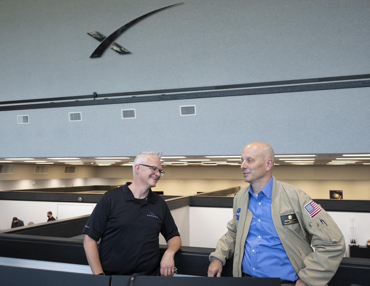 Benji Reed, director of crew mission management at SpaceX, left, and Stephen Koerner, Director of the Flight Operations Directorate at NASA’s Johnson Space Center, right, are seen following the launch of a SpaceX Falcon 9 rocket carrying the company's Crew Dragon spacecraft on the Demo-2 mission with NASA astronauts Douglas Hurley and Robert Behnken onboard, Saturday, May 30, 2020, in  firing room four of the Launch Control Center at NASA’s Kennedy Space Center in Florida. NASA’s SpaceX Demo-2 mission is the first launch with astronauts of the SpaceX Crew Dragon spacecraft and Falcon 9 rocket to the International Space Station as part of the agency’s Commercial Crew Program. The test flight serves as an end-to-end demonstration of SpaceX’s crew transportation system. Behnken and Hurley launched at 3:22 p.m. EDT on Saturday, May 30, from Launch Complex 39A at the Kennedy Space Center. A new era of human spaceflight is set to begin as American astronauts once again launch on an American rocket from American soil to low-Earth orbit for the first time since the conclusion of the Space Shuttle Program in 2011. Photo Credit: (NASA/Joel Kowsky)
