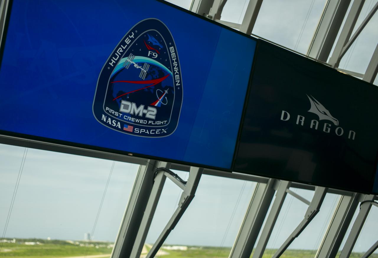 The Demo-2 mission insignia is seen on a monitor inside firing room four following the launch of a SpaceX Falcon 9 rocket carrying the company's Crew Dragon spacecraft on the Demo-2 mission with NASA astronauts Douglas Hurley and Robert Behnken onboard, Saturday, May 30, 2020, in the Launch Control Center at NASA’s Kennedy Space Center in Florida. NASA’s SpaceX Demo-2 mission is the first launch with astronauts of the SpaceX Crew Dragon spacecraft and Falcon 9 rocket to the International Space Station as part of the agency’s Commercial Crew Program. The test flight serves as an end-to-end demonstration of SpaceX’s crew transportation system. Behnken and Hurley launched at 3:22 p.m. EDT on Saturday, May 30, from Launch Complex 39A at the Kennedy Space Center. A new era of human spaceflight is set to begin as American astronauts once again launch on an American rocket from American soil to low-Earth orbit for the first time since the conclusion of the Space Shuttle Program in 2011. Photo Credit: (NASA/Joel Kowsky)