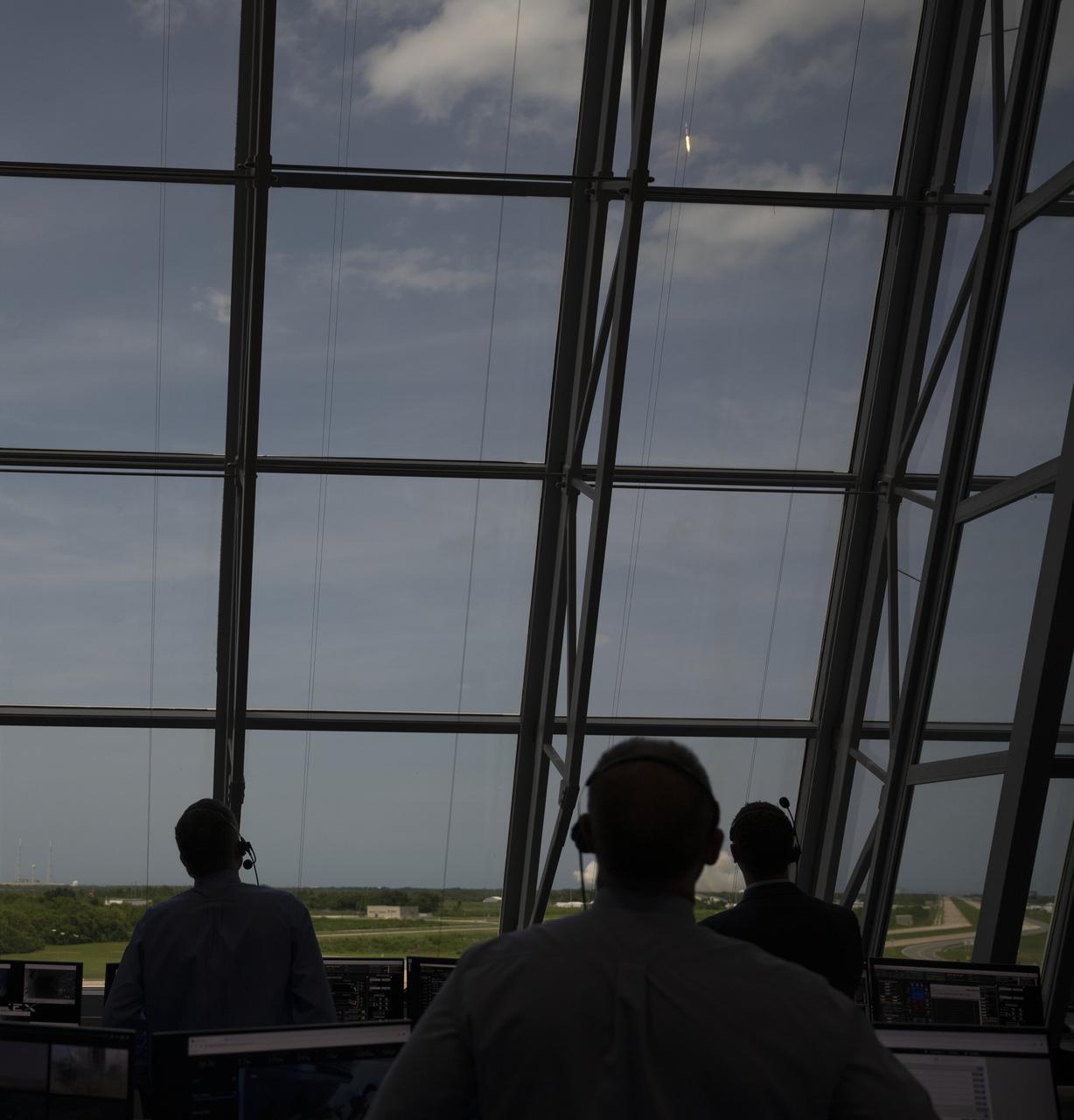 NASA and SpaceX launch teams monitor the launch of a SpaceX Falcon 9 rocket carrying the company's Crew Dragon spacecraft on the Demo-2 mission with NASA astronauts Douglas Hurley and Robert Behnken onboard, Saturday, May 30, 2020, in  firing room four of the Launch Control Center at NASA’s Kennedy Space Center in Florida. NASA’s SpaceX Demo-2 mission is the first launch with astronauts of the SpaceX Crew Dragon spacecraft and Falcon 9 rocket to the International Space Station as part of the agency’s Commercial Crew Program. The test flight serves as an end-to-end demonstration of SpaceX’s crew transportation system. Behnken and Hurley launched at 3:22 p.m. EDT on Saturday, May 30, from Launch Complex 39A at the Kennedy Space Center. A new era of human spaceflight is set to begin as American astronauts once again launch on an American rocket from American soil to low-Earth orbit for the first time since the conclusion of the Space Shuttle Program in 2011. Photo Credit: (NASA/Joel Kowsky)