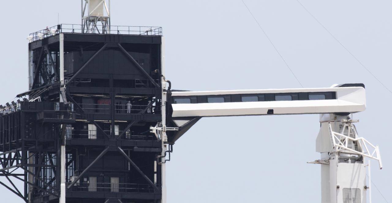 NASA astronauts Robert Behnken and Douglas Hurley are seen on the fixed service structure of Launch Complex 39A before boarding SpaceX’s Crew Dragon spacecraft atop the company’s Flacon 9 rocket before launch of NASA’s SpaceX Demo-2 mission to the International Space Station, Saturday, May 30, 2020, at NASA’s Kennedy Space Center in Florida. The Demo-2 mission is the first launch with astronauts of the SpaceX Crew Dragon spacecraft and Falcon 9 rocket to the International Space Station as part of the agency’s Commercial Crew Program. The test flight serves as an end-to-end demonstration of SpaceX’s crew transportation system. Behnken and Hurley launched at 3:22 p.m. EDT on Saturday, May 30, from Launch Complex 39A at the Kennedy Space Center. A new era of human spaceflight is set to begin as American astronauts once again launch on an American rocket from American soil to low-Earth orbit for the first time since the conclusion of the Space Shuttle Program in 2011. Photo Credit: (NASA/Joel Kowsky)