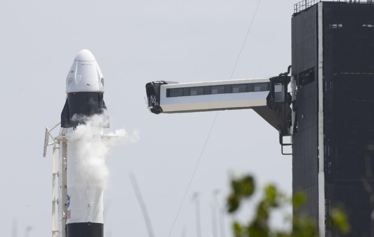 A SpaceX Falcon 9 rocket carrying the company's Crew Dragon spacecraft is seen prior to launch on NASA’s SpaceX Demo-2 mission to the International Space Station with NASA astronauts Robert Behnken and Douglas Hurley onboard, Saturday, May 30, 2020, at Launch Complex 39A at NASA’s Kennedy Space Center in Florida. The Demo-2 mission is the first launch with astronauts of the SpaceX Crew Dragon spacecraft and Falcon 9 rocket to the International Space Station as part of the agency’s Commercial Crew Program. The test flight serves as an end-to-end demonstration of SpaceX’s crew transportation system. Behnken and Hurley launched at 3:22 p.m. EDT on Saturday, May 30, from Launch Complex 39A at the Kennedy Space Center. A new era of human spaceflight is set to begin as American astronauts once again launch on an American rocket from American soil to low-Earth orbit for the first time since the conclusion of the Space Shuttle Program in 2011. Photo Credit: (NASA/Joel Kowsky)