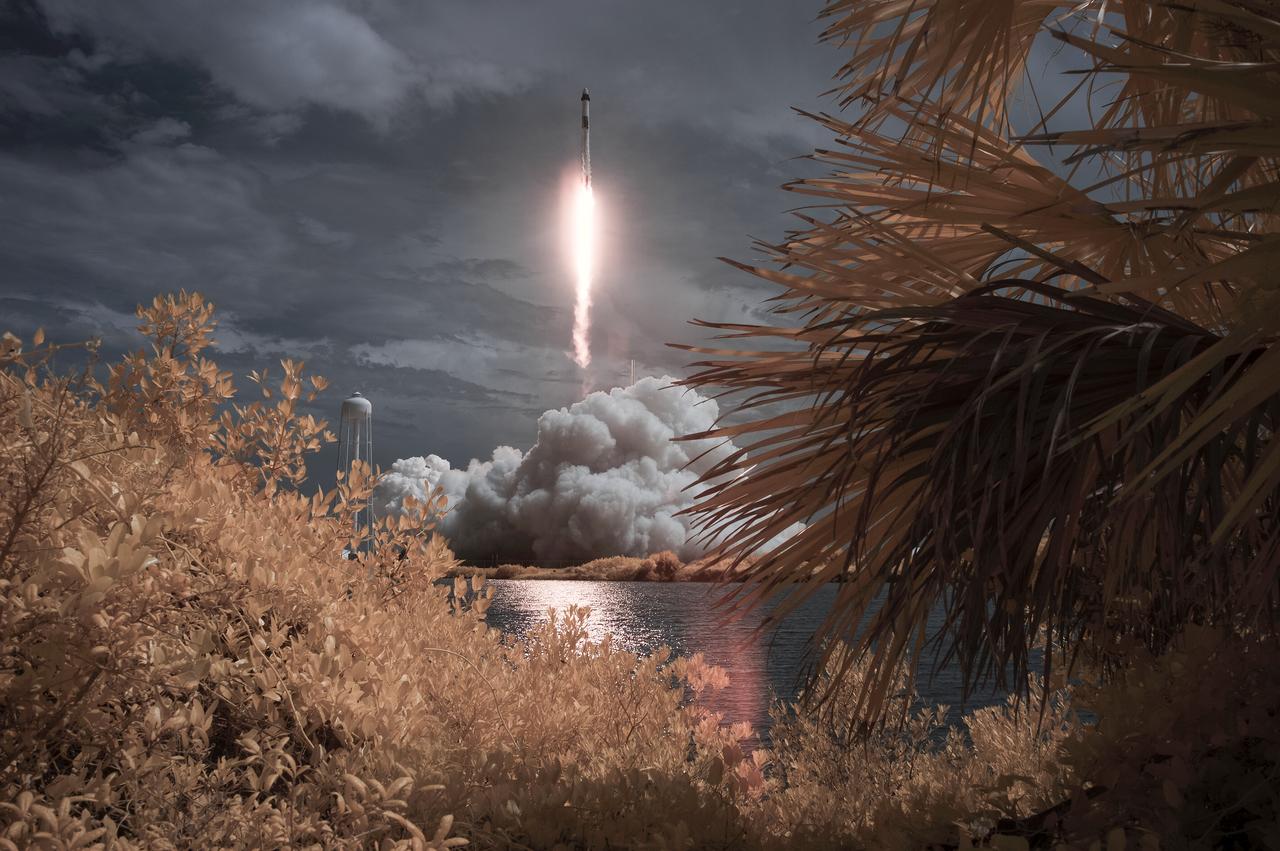 A SpaceX Falcon 9 rocket carrying the company's Crew Dragon spacecraft is seen in this false color infrared exposure as it is launched on NASA’s SpaceX Demo-2 mission to the International Space Station with NASA astronauts Robert Behnken and Douglas Hurley onboard, Saturday, May 30, 2020, at NASA’s Kennedy Space Center in Florida. The Demo-2 mission is the first launch with astronauts of the SpaceX Crew Dragon spacecraft and Falcon 9 rocket to the International Space Station as part of the agency’s Commercial Crew Program. The test flight serves as an end-to-end demonstration of SpaceX’s crew transportation system. Behnken and Hurley launched at 3:22 p.m. EDT on Saturday, May 30, from Launch Complex 39A at the Kennedy Space Center. A new era of human spaceflight is set to begin as American astronauts once again launch on an American rocket from American soil to low-Earth orbit for the first time since the conclusion of the Space Shuttle Program in 2011. Photo Credit: (NASA/Bill Ingalls)
