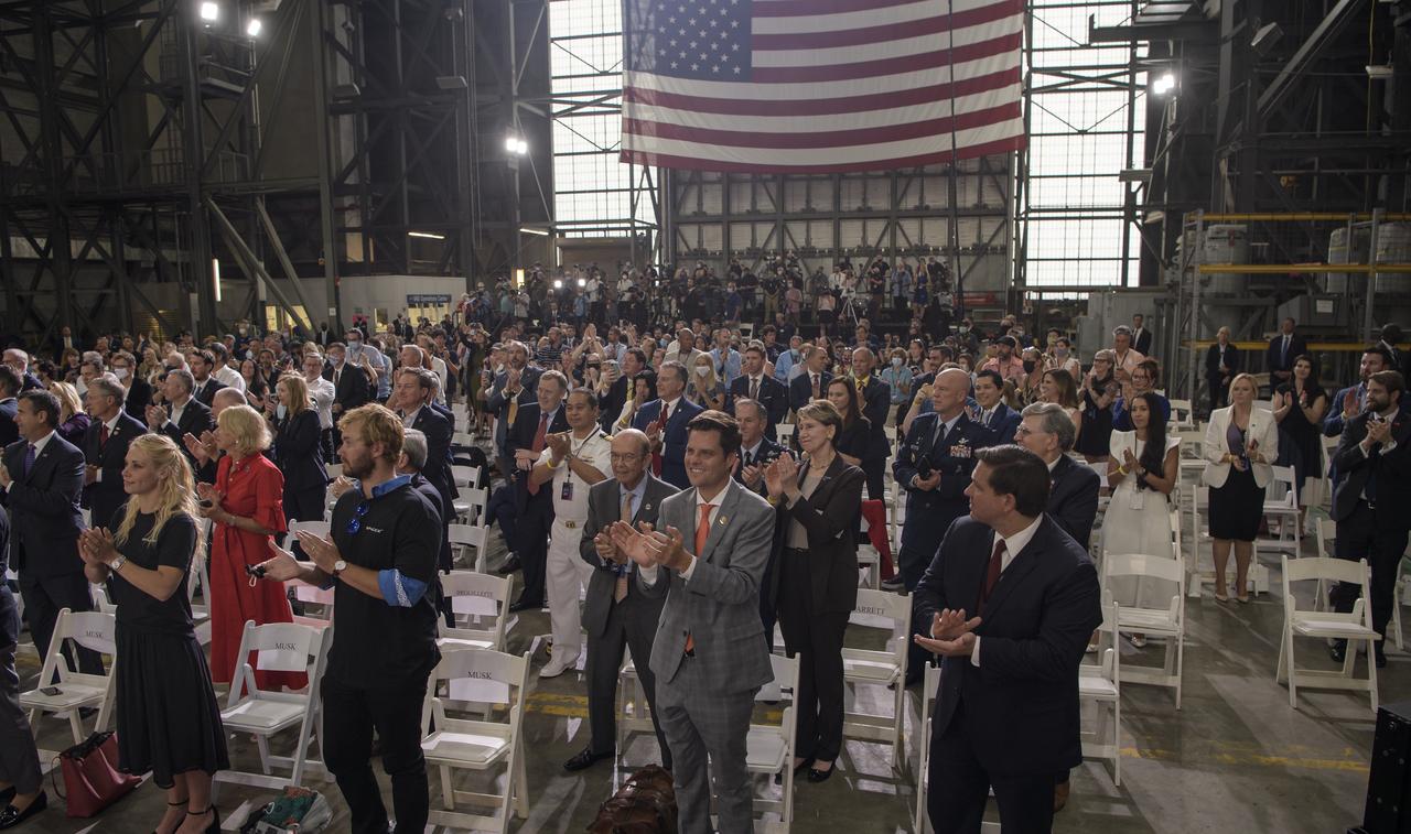 Guest applaud as Vice President Mike Pence  congratulates NASA and SpaceX teams during a speech inside the Vehicle Assembly Building following the launch of a SpaceX Falcon 9 rocket carrying the company's Crew Dragon spacecraft on NASA’s SpaceX Demo-2 mission with NASA astronauts Robert Behnken and Douglas Hurley onboard, Saturday, May 30, 2020, at NASA’s Kennedy Space Center in Florida. NASA’s SpaceX Demo-2 mission is the first launch with astronauts of the SpaceX Crew Dragon spacecraft and Falcon 9 rocket to the International Space Station as part of the agency’s Commercial Crew Program. The test flight serves as an end-to-end demonstration of SpaceX’s crew transportation system. Behnken and Hurley launched at 3:22 p.m. EDT on Saturday, May 30, from Launch Complex 39A at the Kennedy Space Center. A new era of human spaceflight is set to begin as American astronauts once again launch on an American rocket from American soil to low-Earth orbit for the first time since the conclusion of the Space Shuttle Program in 2011. Photo Credit: (NASA/Bill Ingalls)