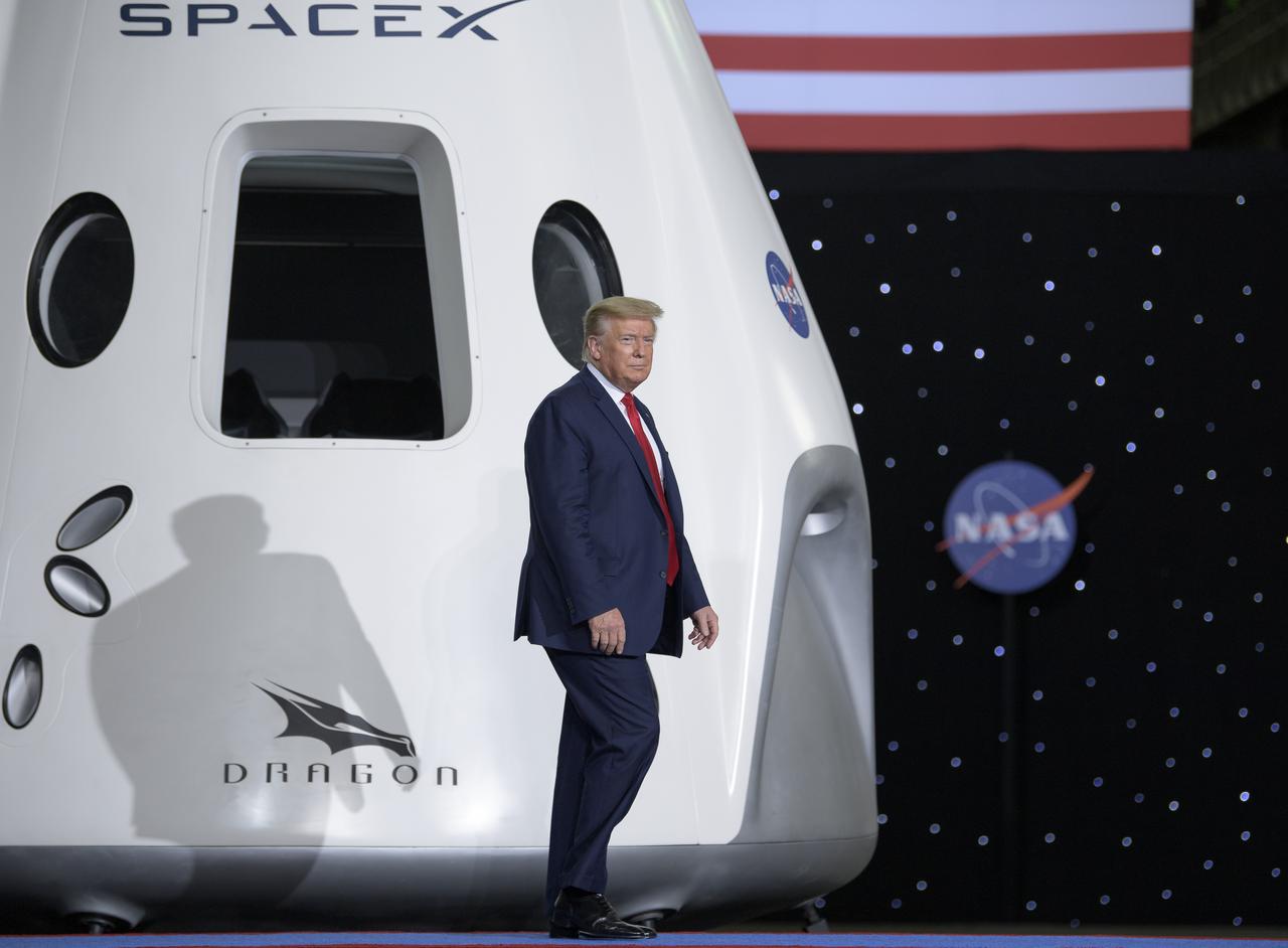 President Donald Trump steps on stage to give remarks inside the Vehicle Assembly Building following the launch of a SpaceX Falcon 9 rocket carrying the company's Crew Dragon spacecraft on NASA’s SpaceX Demo-2 mission with NASA astronauts Robert Behnken and Douglas Hurley onboard, Saturday, May 30, 2020, at NASA’s Kennedy Space Center in Florida. NASA’s SpaceX Demo-2 mission is the first launch with astronauts of the SpaceX Crew Dragon spacecraft and Falcon 9 rocket to the International Space Station as part of the agency’s Commercial Crew Program. The test flight serves as an end-to-end demonstration of SpaceX’s crew transportation system. Behnken and Hurley launched at 3:22 p.m. EDT on Saturday, May 30, from Launch Complex 39A at the Kennedy Space Center. A new era of human spaceflight is set to begin as American astronauts once again launch on an American rocket from American soil to low-Earth orbit for the first time since the conclusion of the Space Shuttle Program in 2011. Photo Credit: (NASA/Bill Ingalls)