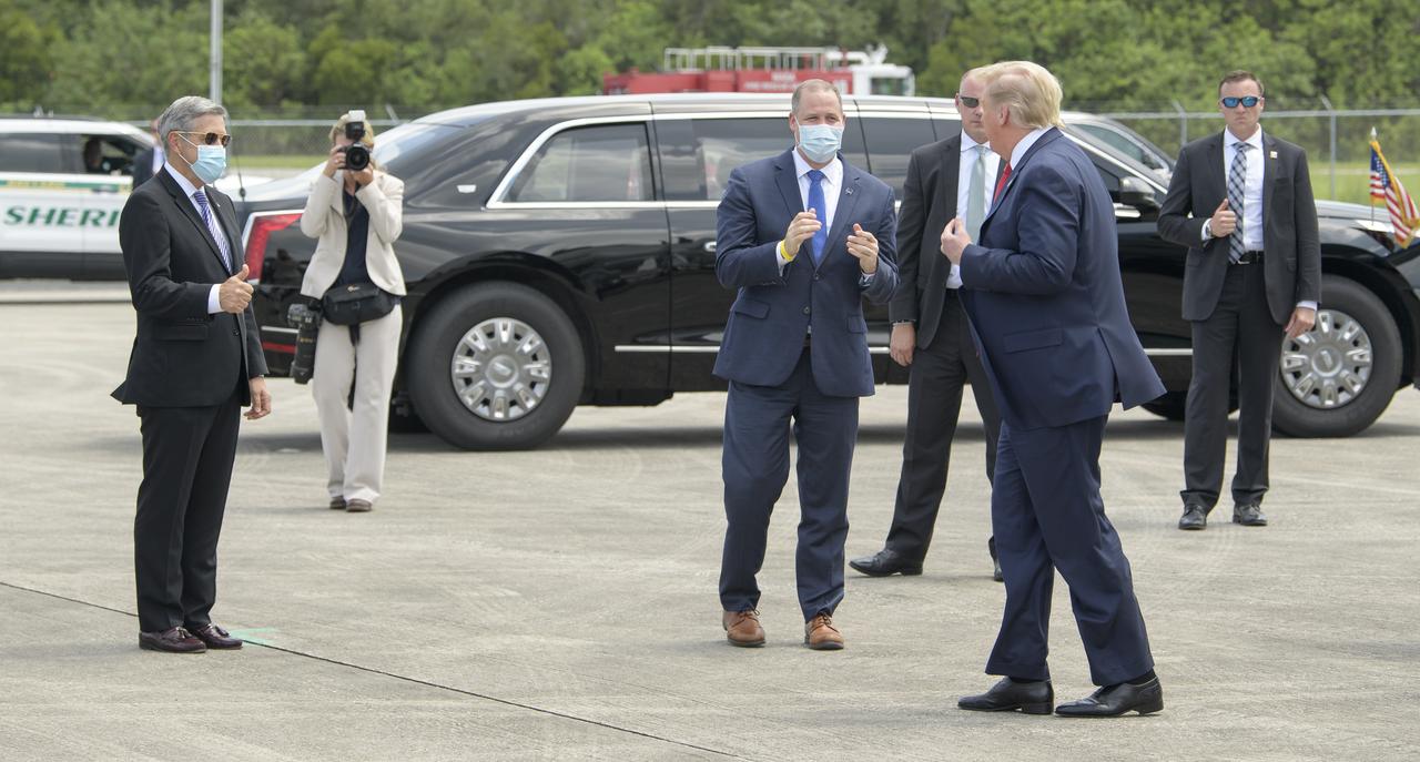 NASA Kennedy Space Center Director Bob Cabana, left, and NASA Administrator Jim Bridenstine welcome President Donald Trump after he arrived at NASA’s Kennedy Space Center Launch and Landing Facility on Air Force One ahead of SpaceX’s Demo-2 mission, Saturday, May 30, 2020, in Florida. NASA’s SpaceX Demo-2 mission is the first launch with astronauts of the SpaceX Crew Dragon spacecraft and Falcon 9 rocket to the International Space Station as part of the agency’s Commercial Crew Program. The test flight serves as an end-to-end demonstration of SpaceX’s crew transportation system. Behnken and Hurley are scheduled to launch at 3:22 p.m. EDT on Saturday, May 30, from Launch Complex 39A at the Kennedy Space Center. A new era of human spaceflight is set to begin as American astronauts once again launch on an American rocket from American soil to low-Earth orbit for the first time since the conclusion of the Space Shuttle Program in 2011.  Photo Credit: (NASA/Bill Ingalls)