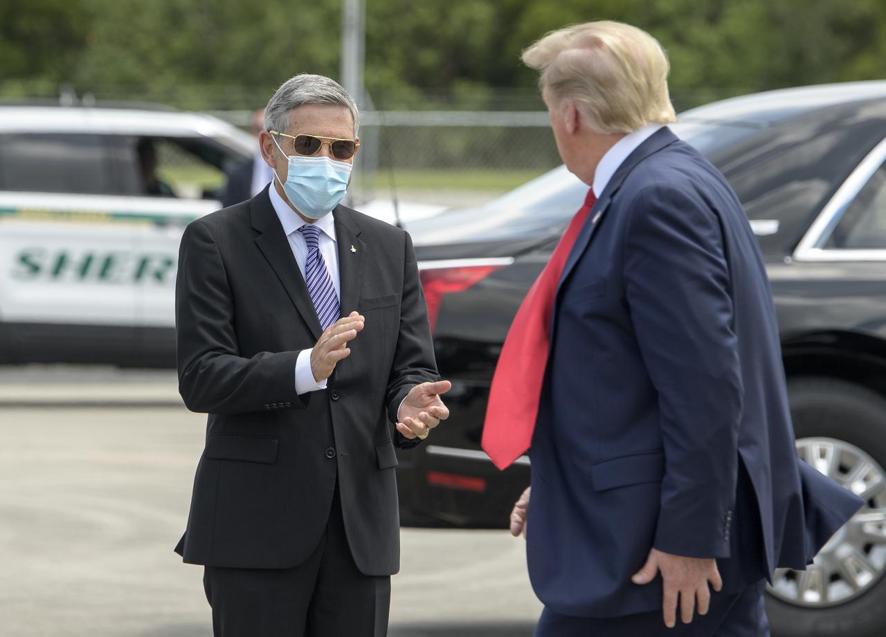 NASA Kennedy Space Center Director Bob Cabana welcomes President Donald Trump after he arrived at NASA’s Kennedy Space Center Launch and Landing Facility on Air Force One ahead of SpaceX’s Demo-2 mission, Saturday, May 30, 2020, in Florida. NASA’s SpaceX Demo-2 mission is the first launch with astronauts of the SpaceX Crew Dragon spacecraft and Falcon 9 rocket to the International Space Station as part of the agency’s Commercial Crew Program. The test flight serves as an end-to-end demonstration of SpaceX’s crew transportation system. Behnken and Hurley are scheduled to launch at 3:22 p.m. EDT on Saturday, May 30, from Launch Complex 39A at the Kennedy Space Center. A new era of human spaceflight is set to begin as American astronauts once again launch on an American rocket from American soil to low-Earth orbit for the first time since the conclusion of the Space Shuttle Program in 2011.  Photo Credit: (NASA/Bill Ingalls)
