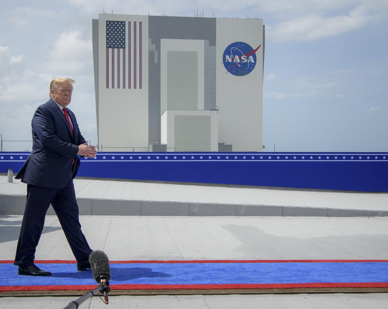 President Donald Trump walks out on to the roof of the Operations Support Building II to view the launch of a SpaceX Falcon 9 rocket carrying the company's Crew Dragon spacecraft on NASA’s SpaceX Demo-2 mission with NASA astronauts Robert Behnken and Douglas Hurley onboard, Saturday, May 30, 2020, at NASA’s Kennedy Space Center in Florida. NASA’s SpaceX Demo-2 mission is the first launch with astronauts of the SpaceX Crew Dragon spacecraft and Falcon 9 rocket to the International Space Station as part of the agency’s Commercial Crew Program. The test flight serves as an end-to-end demonstration of SpaceX’s crew transportation system. Behnken and Hurley launched at 3:22 p.m. EDT on Saturday, May 30, from Launch Complex 39A at the Kennedy Space Center. A new era of human spaceflight is set to begin as American astronauts once again launch on an American rocket from American soil to low-Earth orbit for the first time since the conclusion of the Space Shuttle Program in 2011. Photo Credit: (NASA/Bill Ingalls)