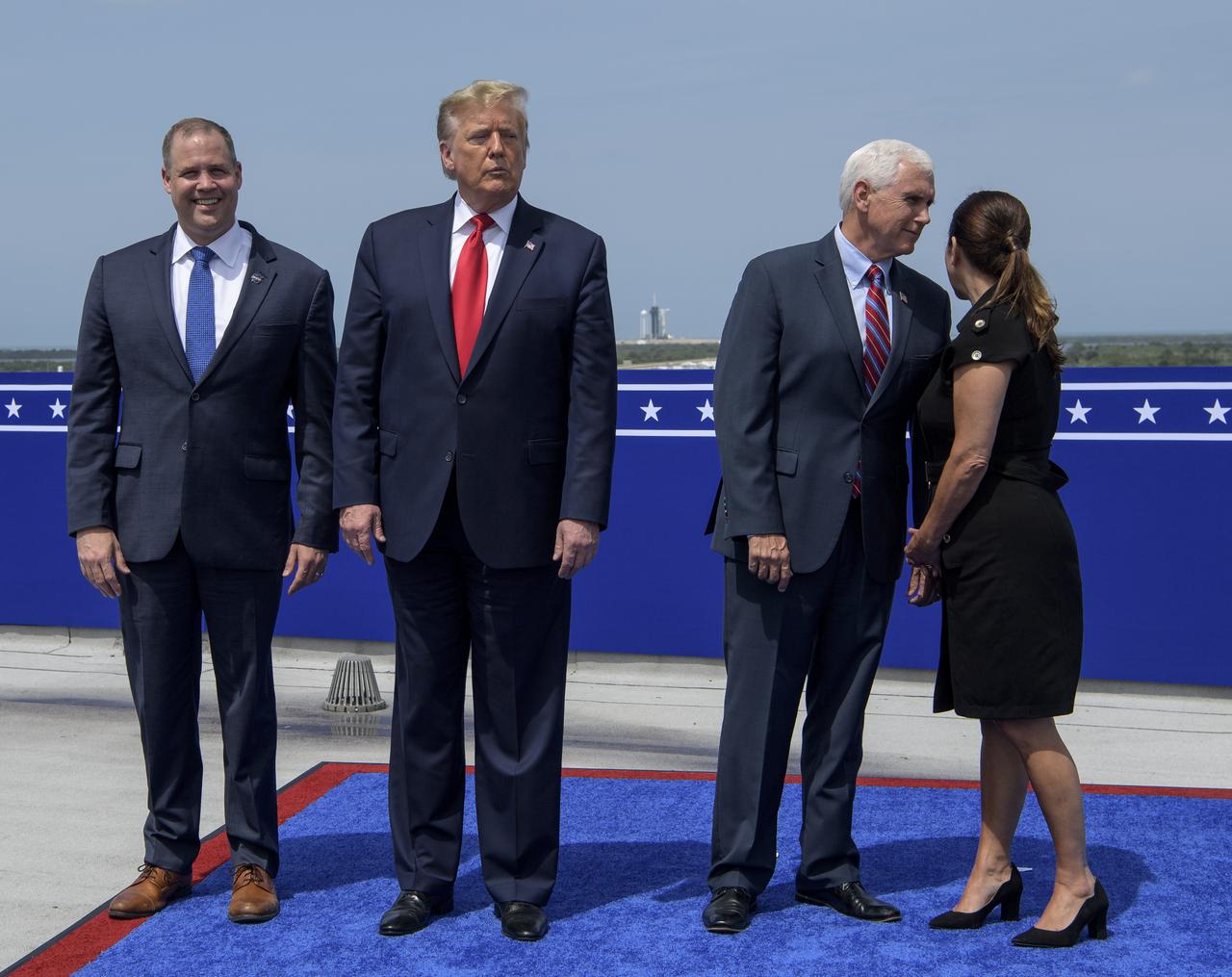 NASA Administrator Jim Bridenstine, left, President Donald Trump, Vice President Mike Pence, and Second Lady Karen Pence, prepare to watch the launch of a SpaceX Falcon 9 rocket carrying the company's Crew Dragon spacecraft on NASA’s SpaceX Demo-2 mission with NASA astronauts Robert Behnken and Douglas Hurley onboard, Saturday, May 30, 2020, from the balcony of Operations Support Building II at NASA’s Kennedy Space Center in Florida. NASA’s SpaceX Demo-2 mission is the first launch with astronauts of the SpaceX Crew Dragon spacecraft and Falcon 9 rocket to the International Space Station as part of the agency’s Commercial Crew Program. The test flight serves as an end-to-end demonstration of SpaceX’s crew transportation system. Behnken and Hurley launched at 3:22 p.m. EDT on Saturday, May 30, from Launch Complex 39A at the Kennedy Space Center. A new era of human spaceflight is set to begin as American astronauts once again launch on an American rocket from American soil to low-Earth orbit for the first time since the conclusion of the Space Shuttle Program in 2011. Photo Credit: (NASA/Bill Ingalls)