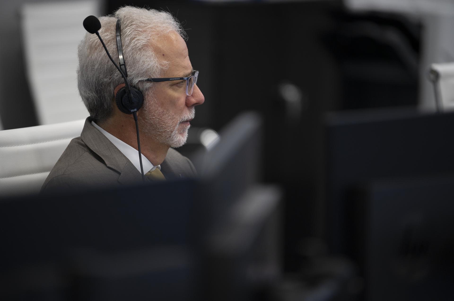 Mark Geyer, Director of NASA’s Johnson Space Center monitors the countdown of the launch of a SpaceX Falcon 9 rocket