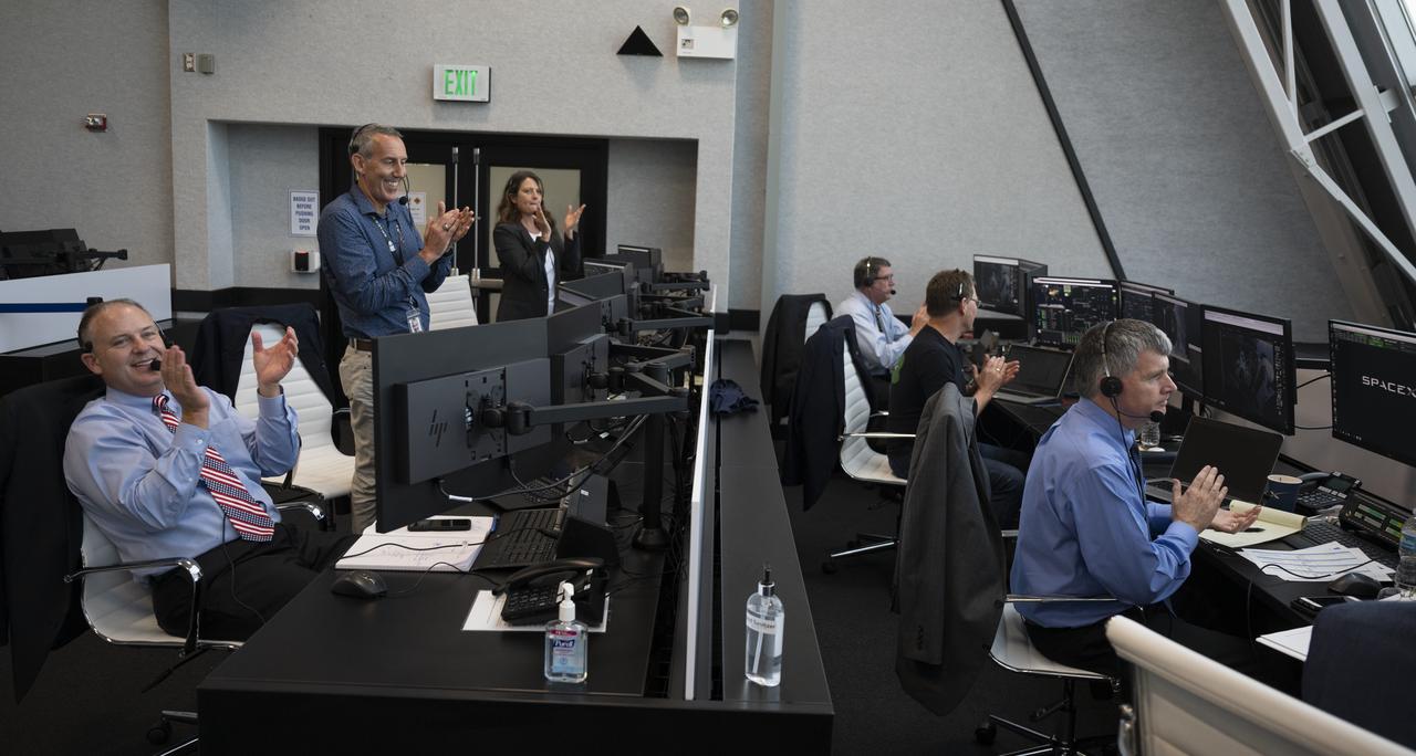 NASA and SpaceX managers are seen during launch of a SpaceX Falcon 9 rocket carrying the company's Crew Dragon spacecraft on the Demo-2 mission with NASA astronauts Douglas Hurley and Robert Behnken onboard, Saturday, May 30, 2020, in  firing room four of the Launch Control Center at NASA’s Kennedy Space Center in Florida. NASA’s SpaceX Demo-2 mission is the first launch with astronauts of the SpaceX Crew Dragon spacecraft and Falcon 9 rocket to the International Space Station as part of the agency’s Commercial Crew Program. The test flight serves as an end-to-end demonstration of SpaceX’s crew transportation system. Behnken and Hurley launched at 3:22 p.m. EDT on Saturday, May 30, from Launch Complex 39A at the Kennedy Space Center. A new era of human spaceflight is set to begin as American astronauts once again launch on an American rocket from American soil to low-Earth orbit for the first time since the conclusion of the Space Shuttle Program in 2011. Photo Credit: (NASA/Joel Kowsky)