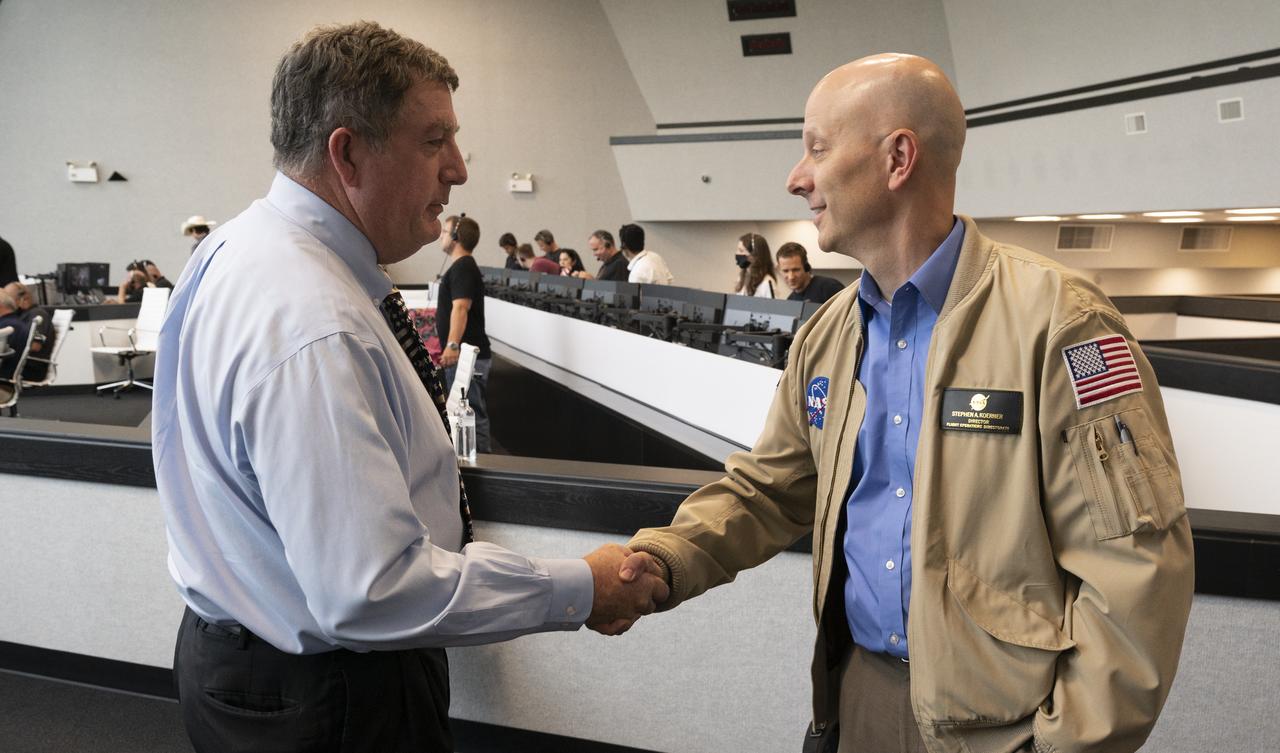 NASA International Space Station Program Manger Kirk Shireman, left, shakes hands with Stephen Koerner, Director of the Flight Operations Directorate at NASA’s Johnson Space Center, following the launch of a SpaceX Falcon 9 rocket carrying the company's Crew Dragon spacecraft on the Demo-2 mission with NASA astronauts Douglas Hurley and Robert Behnken onboard, Saturday, May 30, 2020, in  firing room four of the Launch Control Center at NASA’s Kennedy Space Center in Florida. NASA’s SpaceX Demo-2 mission is the first launch with astronauts of the SpaceX Crew Dragon spacecraft and Falcon 9 rocket to the International Space Station as part of the agency’s Commercial Crew Program. The test flight serves as an end-to-end demonstration of SpaceX’s crew transportation system. Behnken and Hurley launched at 3:22 p.m. EDT on Saturday, May 30, from Launch Complex 39A at the Kennedy Space Center. A new era of human spaceflight is set to begin as American astronauts once again launch on an American rocket from American soil to low-Earth orbit for the first time since the conclusion of the Space Shuttle Program in 2011. Photo Credit: (NASA/Joel Kowsky)