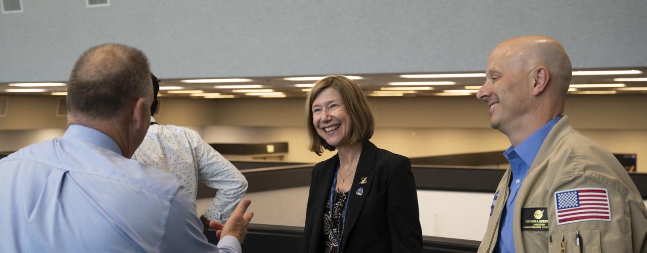 Kathy Lueders, manager of NASA's Commercial Crew Program, center, is seen with Norm Knight, deputy director of Flight Operations at NASA's Johnson Space Center, left, and Stephen Koerner, Director of the Flight Operations Directorate at NASA’s Johnson Space Center, right, following launch of a SpaceX Falcon 9 rocket carrying the company's Crew Dragon spacecraft on the Demo-2 mission with NASA astronauts Douglas Hurley and Robert Behnken onboard, Saturday, May 30, 2020, in  firing room four of the Launch Control Center at NASA’s Kennedy Space Center in Florida. NASA’s SpaceX Demo-2 mission is the first launch with astronauts of the SpaceX Crew Dragon spacecraft and Falcon 9 rocket to the International Space Station as part of the agency’s Commercial Crew Program. The test flight serves as an end-to-end demonstration of SpaceX’s crew transportation system. Behnken and Hurley launched at 3:22 p.m. EDT on Saturday, May 30, from Launch Complex 39A at the Kennedy Space Center. A new era of human spaceflight is set to begin as American astronauts once again launch on an American rocket from American soil to low-Earth orbit for the first time since the conclusion of the Space Shuttle Program in 2011. Photo Credit: (NASA/Joel Kowsky)