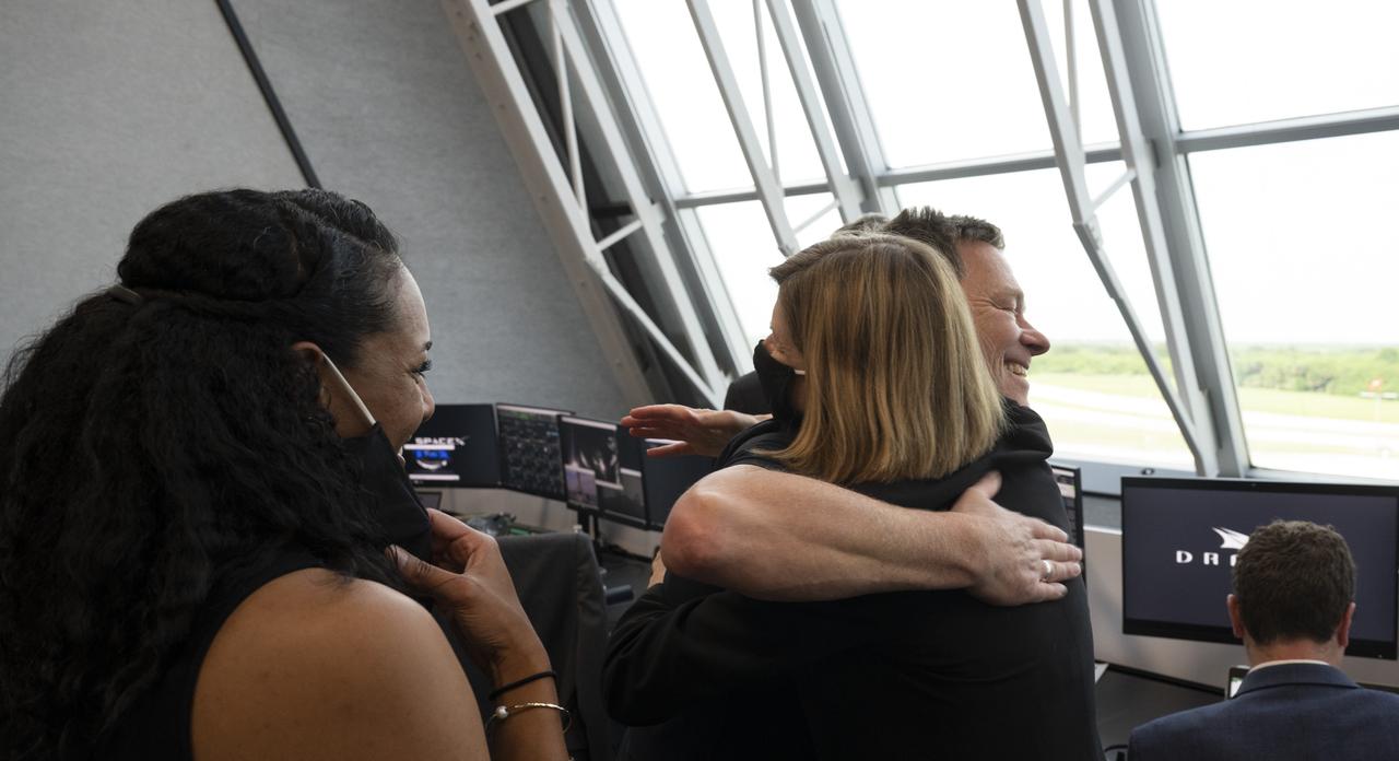 Hans Koenigsmann, vice president for build and flight reliability at SpaceX hugs Kathy Lueders, manager of NASA's Commercial Crew Program, following the launch of a SpaceX Falcon 9 rocket carrying the company's Crew Dragon spacecraft on the Demo-2 mission with NASA astronauts Douglas Hurley and Robert Behnken onboard, Saturday, May 30, 2020, in  firing room four of the Launch Control Center at NASA’s Kennedy Space Center in Florida. NASA’s SpaceX Demo-2 mission is the first launch with astronauts of the SpaceX Crew Dragon spacecraft and Falcon 9 rocket to the International Space Station as part of the agency’s Commercial Crew Program. The test flight serves as an end-to-end demonstration of SpaceX’s crew transportation system. Behnken and Hurley launched at 3:22 p.m. EDT on Saturday, May 30, from Launch Complex 39A at the Kennedy Space Center. A new era of human spaceflight is set to begin as American astronauts once again launch on an American rocket from American soil to low-Earth orbit for the first time since the conclusion of the Space Shuttle Program in 2011. Photo Credit: (NASA/Joel Kowsky)