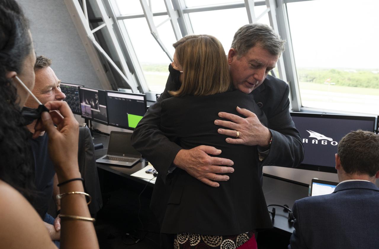 NASA International Space Station Program Manger Kirk Shireman hugs Kathy Lueders, manager of NASA's Commercial Crew Program, following the launch of a SpaceX Falcon 9 rocket carrying the company's Crew Dragon spacecraft on the Demo-2 mission with NASA astronauts Douglas Hurley and Robert Behnken onboard, Saturday, May 30, 2020, in  firing room four of the Launch Control Center at NASA’s Kennedy Space Center in Florida. NASA’s SpaceX Demo-2 mission is the first launch with astronauts of the SpaceX Crew Dragon spacecraft and Falcon 9 rocket to the International Space Station as part of the agency’s Commercial Crew Program. The test flight serves as an end-to-end demonstration of SpaceX’s crew transportation system. Behnken and Hurley launched at 3:22 p.m. EDT on Saturday, May 30, from Launch Complex 39A at the Kennedy Space Center. A new era of human spaceflight is set to begin as American astronauts once again launch on an American rocket from American soil to low-Earth orbit for the first time since the conclusion of the Space Shuttle Program in 2011. Photo Credit: (NASA/Joel Kowsky)