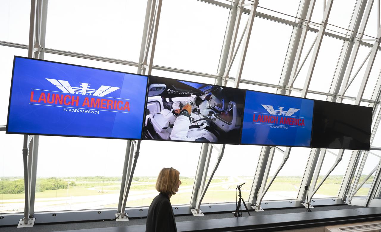 Kathy Lueders, manager of NASA's Commercial Crew Program walks past a monitor displaying video of NASA astronauts Robert Behnken and Douglas Hurley onboard SpaceX’s Crew Dragon spacecraft following launch atop the company’s Falcon 9 rocket the Demo-2 to the International Space Station, Saturday, May 30, 2020, in  firing room four of the Launch Control Center at NASA’s Kennedy Space Center in Florida. NASA’s SpaceX Demo-2 mission is the first launch with astronauts of the SpaceX Crew Dragon spacecraft and Falcon 9 rocket to the International Space Station as part of the agency’s Commercial Crew Program. The test flight serves as an end-to-end demonstration of SpaceX’s crew transportation system. Behnken and Hurley launched at 3:22 p.m. EDT on Saturday, May 30, from Launch Complex 39A at the Kennedy Space Center. A new era of human spaceflight is set to begin as American astronauts once again launch on an American rocket from American soil to low-Earth orbit for the first time since the conclusion of the Space Shuttle Program in 2011. Photo Credit: (NASA/Joel Kowsky)