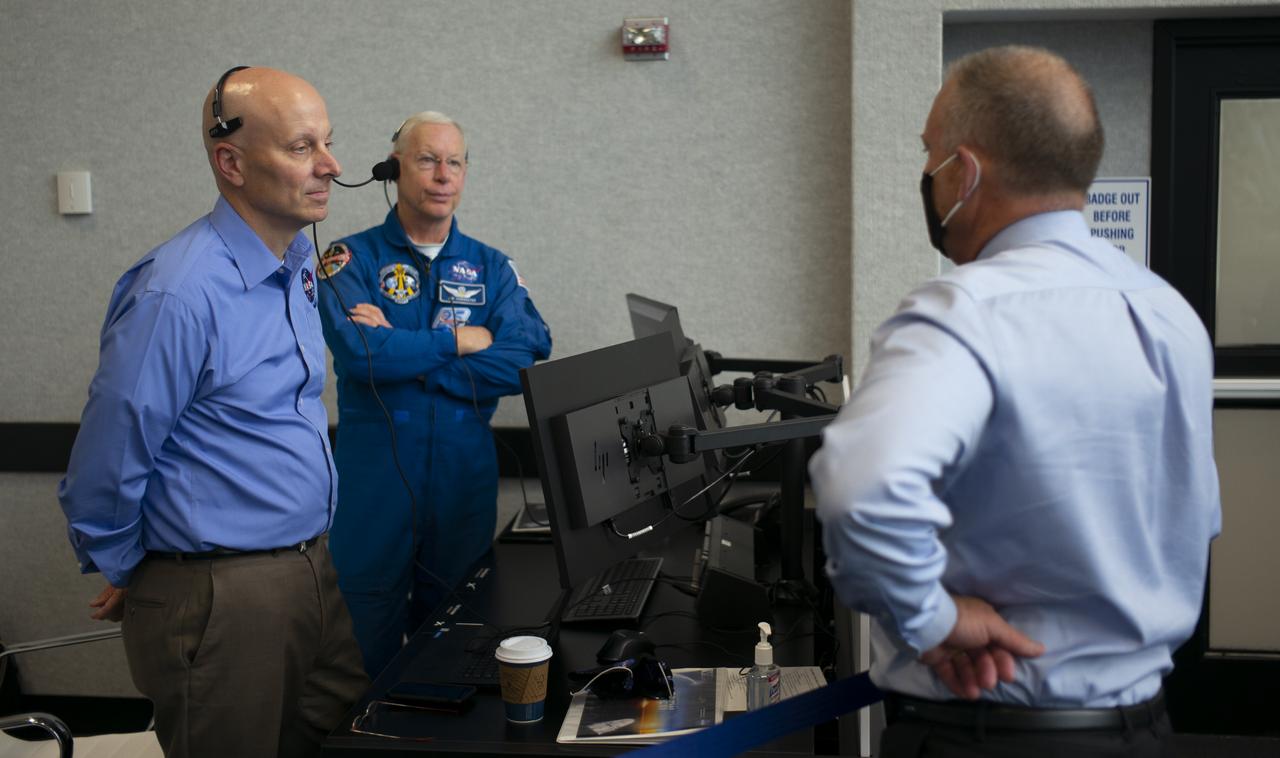 Stephen Koerner, Director of the Flight Operations Directorate at NASA’s Johnson Space Center, left, Pat Forrester, NASA’s chief of the astronaut office, and Norm Knight, deputy director of Flight Operations at NASA's Johnson Space Center are seen during countdown of the launch of a SpaceX Falcon 9 rocket carrying the company's Crew Dragon spacecraft on NASA’s SpaceX Demo-2 mission with NASA astronauts Robert Behnken and Douglas Hurley onboard, Saturday, May 30, 2020, in firing room four of the Launch Control Center at NASA’s Kennedy Space Center in Florida. NASA’s SpaceX Demo-2 mission is the first launch with astronauts of the SpaceX Crew Dragon spacecraft and Falcon 9 rocket to the International Space Station as part of the agency’s Commercial Crew Program. The test flight serves as an end-to-end demonstration of SpaceX’s crew transportation system. Behnken and Hurley launched at 3:22 p.m. EDT on Saturday, May 30, from Launch Complex 39A at the Kennedy Space Center. A new era of human spaceflight is set to begin as American astronauts once again launch on an American rocket from American soil to low-Earth orbit for the first time since the conclusion of the Space Shuttle Program in 2011. Photo Credit: (NASA/Joel Kowsky)