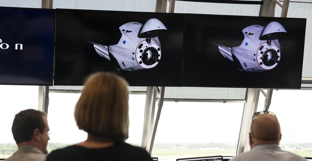 Views of SpaceX’s Crew Dragon spacecraft with NASA astronauts Douglas Hurley and Robert Behnken onboard are seen on monitors inside firing room four as the spacecraft approaches to the International Space Station for docking, Sunday, May 31, 2020, in firing room four of the Launch Control Center at NASA’s Kennedy Space Center in Florida. NASA’s SpaceX Demo-2 mission is the first launch with astronauts of the SpaceX Crew Dragon spacecraft and Falcon 9 rocket to the International Space Station as part of the agency’s Commercial Crew Program. The test flight serves as an end-to-end demonstration of SpaceX’s crew transportation system. Behnken and Hurley launched at 3:22 p.m. EDT on Saturday, May 30, from Launch Complex 39A at the Kennedy Space Center and docked with the International Space Station at 10:16am EDT on Sunday, May 31.. A new era of human spaceflight is set to begin as American astronauts once again launch on an American rocket from American soil to low-Earth orbit for the first time since the conclusion of the Space Shuttle Program in 2011. Photo Credit: (NASA/Joel Kowsky)