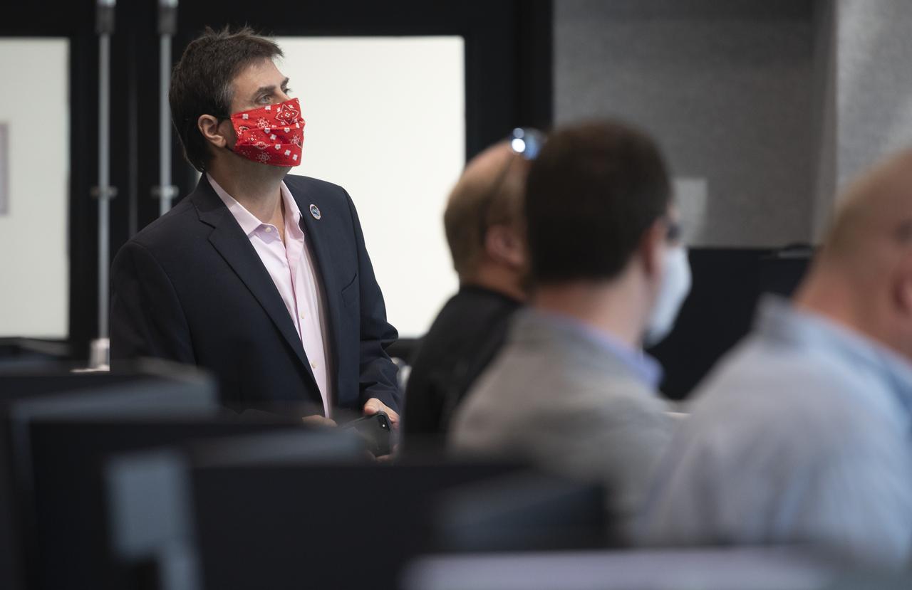 Joel Montalbano, NASA’s International Space Station Deputy Program Manager, watches the docking of SpaceX’s Crew Dragon spacecraft with NASA astronauts Douglas Hurley and Robert Behnken onboard to the International Space Station, Sunday, May 31, 2020, in firing room four of the Launch Control Center at NASA’s Kennedy Space Center in Florida. NASA’s SpaceX Demo-2 mission is the first launch with astronauts of the SpaceX Crew Dragon spacecraft and Falcon 9 rocket to the International Space Station as part of the agency’s Commercial Crew Program. The test flight serves as an end-to-end demonstration of SpaceX’s crew transportation system. Behnken and Hurley launched at 3:22 p.m. EDT on Saturday, May 30, from Launch Complex 39A at the Kennedy Space Center and docked with the International Space Station at 10:16am EDT on Sunday, May 31.. A new era of human spaceflight is set to begin as American astronauts once again launch on an American rocket from American soil to low-Earth orbit for the first time since the conclusion of the Space Shuttle Program in 2011. Photo Credit: (NASA/Joel Kowsky)
