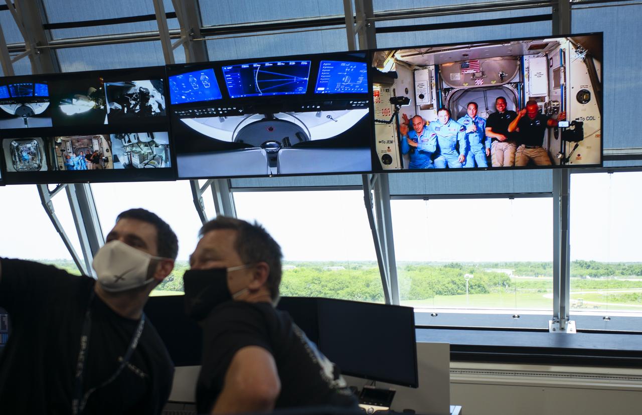NASA astronauts Robert Behnken and Douglas Hurley are seen with Expedition 53 Commander NASA astronaut Chris Cassidy and cosmonauts Anatoly Ivanishin and Ivan Vagner of Roscosmos onboard the International Space Station after hatches were opened between SpaceX’s Crew Dragon spacecraft the orbiting laboratory, Sunday, May 31, 2020, in firing room four of the Launch Control Center at NASA’s Kennedy Space Center in Florida. NASA’s SpaceX Demo-2 mission is the first launch with astronauts of the SpaceX Crew Dragon spacecraft and Falcon 9 rocket to the International Space Station as part of the agency’s Commercial Crew Program. The test flight serves as an end-to-end demonstration of SpaceX’s crew transportation system. Behnken and Hurley launched at 3:22 p.m. EDT on Saturday, May 30, from Launch Complex 39A at the Kennedy Space Center and docked with the International Space Station at 10:16am EDT on Sunday, May 31. A new era of human spaceflight is set to begin as American astronauts once again launch on an American rocket from American soil to low-Earth orbit for the first time since the conclusion of the Space Shuttle Program in 2011. Photo Credit: (NASA/Joel Kowsky)
