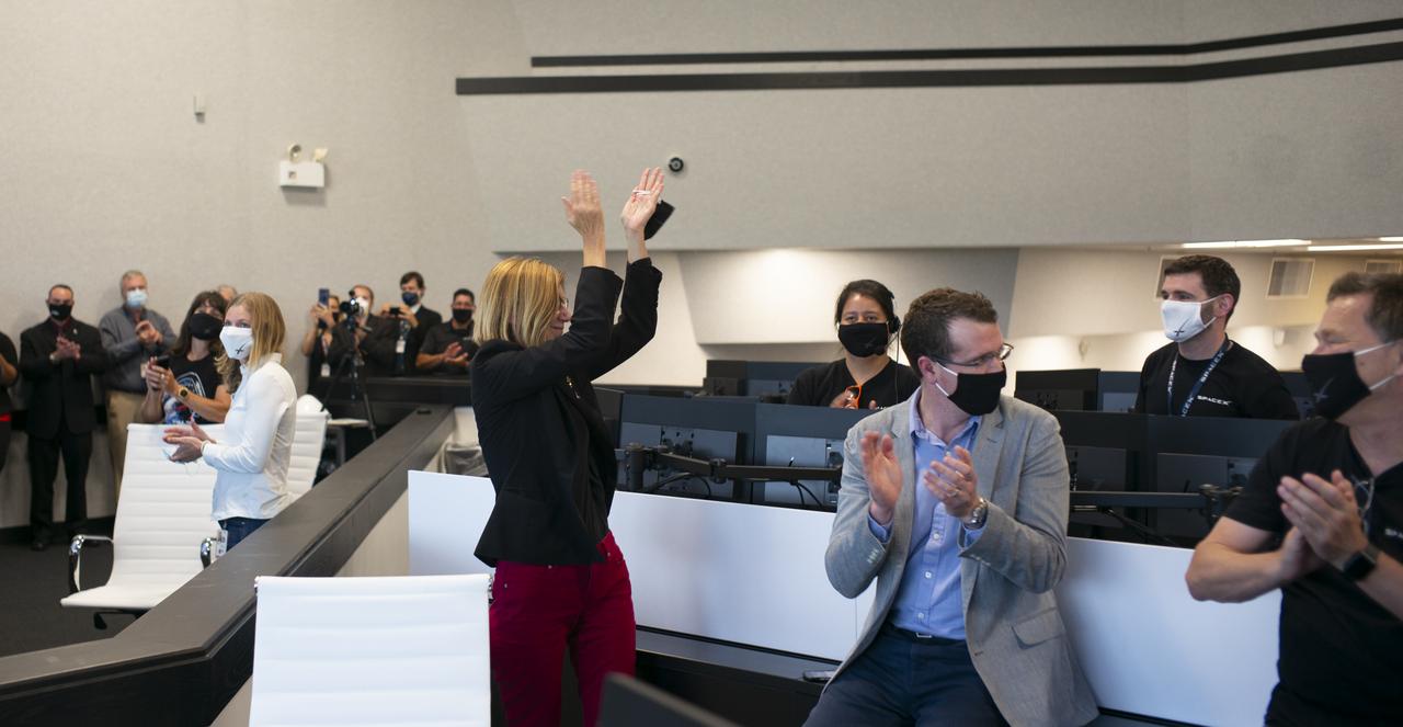 Kathy Lueders, manager of NASA's Commercial Crew Program, applauds the SpaceX and NASA teams present in firing room four after the hatches were opened between SpaceX’s Crew Dragon spacecraft with NASA astronauts Douglas Hurley and Robert Behnken onboard and the International Space Station, Sunday, May 31, 2020, in  firing room four of the Launch Control Center at NASA’s Kennedy Space Center in Florida. NASA’s SpaceX Demo-2 mission is the first launch with astronauts of the SpaceX Crew Dragon spacecraft and Falcon 9 rocket to the International Space Station as part of the agency’s Commercial Crew Program. The test flight serves as an end-to-end demonstration of SpaceX’s crew transportation system. Behnken and Hurley launched at 3:22 p.m. EDT on Saturday, May 30, from Launch Complex 39A at the Kennedy Space Center and docked with the International Space Station at 10:16am EDT on Sunday, May 31.. A new era of human spaceflight is set to begin as American astronauts once again launch on an American rocket from American soil to low-Earth orbit for the first time since the conclusion of the Space Shuttle Program in 2011. Photo Credit: (NASA/Joel Kowsky)