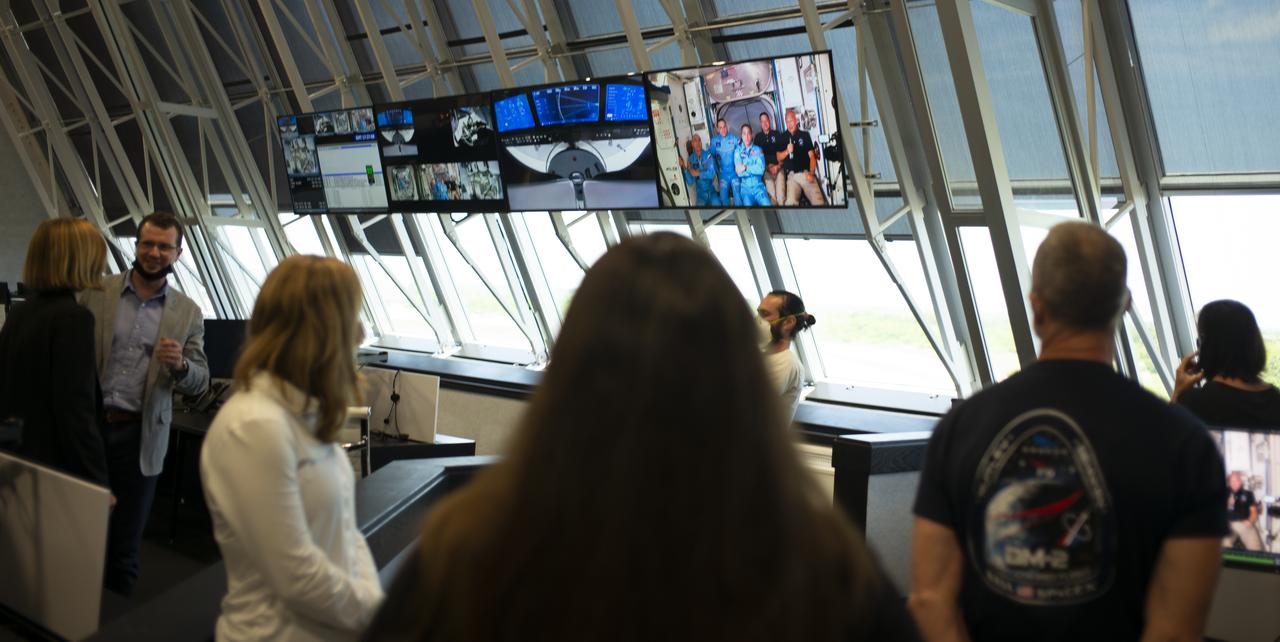 NASA astronauts Robert Behnken and Douglas Hurley are seen with Expedition 53 Commander NASA astronaut Chris Cassidy and cosmonauts Anatoly Ivanishin and Ivan Vagner of Roscosmos onboard the International Space Station after hatches were opened between SpaceX’s Crew Dragon spacecraft the orbiting laboratory, Sunday, May 31, 2020, in firing room four of the Launch Control Center at NASA’s Kennedy Space Center in Florida. NASA’s SpaceX Demo-2 mission is the first launch with astronauts of the SpaceX Crew Dragon spacecraft and Falcon 9 rocket to the International Space Station as part of the agency’s Commercial Crew Program. The test flight serves as an end-to-end demonstration of SpaceX’s crew transportation system. Behnken and Hurley launched at 3:22 p.m. EDT on Saturday, May 30, from Launch Complex 39A at the Kennedy Space Center and docked with the International Space Station at 10:16am EDT on Sunday, May 31. A new era of human spaceflight is set to begin as American astronauts once again launch on an American rocket from American soil to low-Earth orbit for the first time since the conclusion of the Space Shuttle Program in 2011. Photo Credit: (NASA/Joel Kowsky)