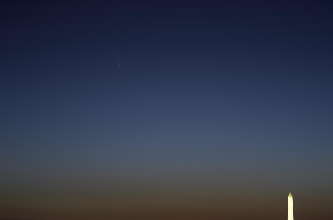 Comet NEOWISE is seen, upper left, before sunrise over Washington, Sunday, July 12, 2020. The comet was discovered by NASA’s Near-Earth Object Wide-field Infrared Survey Explorer, or NEOWISE, on March 27. Since then, the comet — called comet C/2020 F3 NEOWISE and nicknamed comet NEOWISE — has been spotted by several NASA spacecraft, including Parker Solar Probe, NASA’s Solar and Terrestrial Relations Observatory, the ESA/NASA Solar and Heliospheric Observatory, and astronauts aboard the International Space Station. Photo Credit: (NASA/Bill Ingalls)