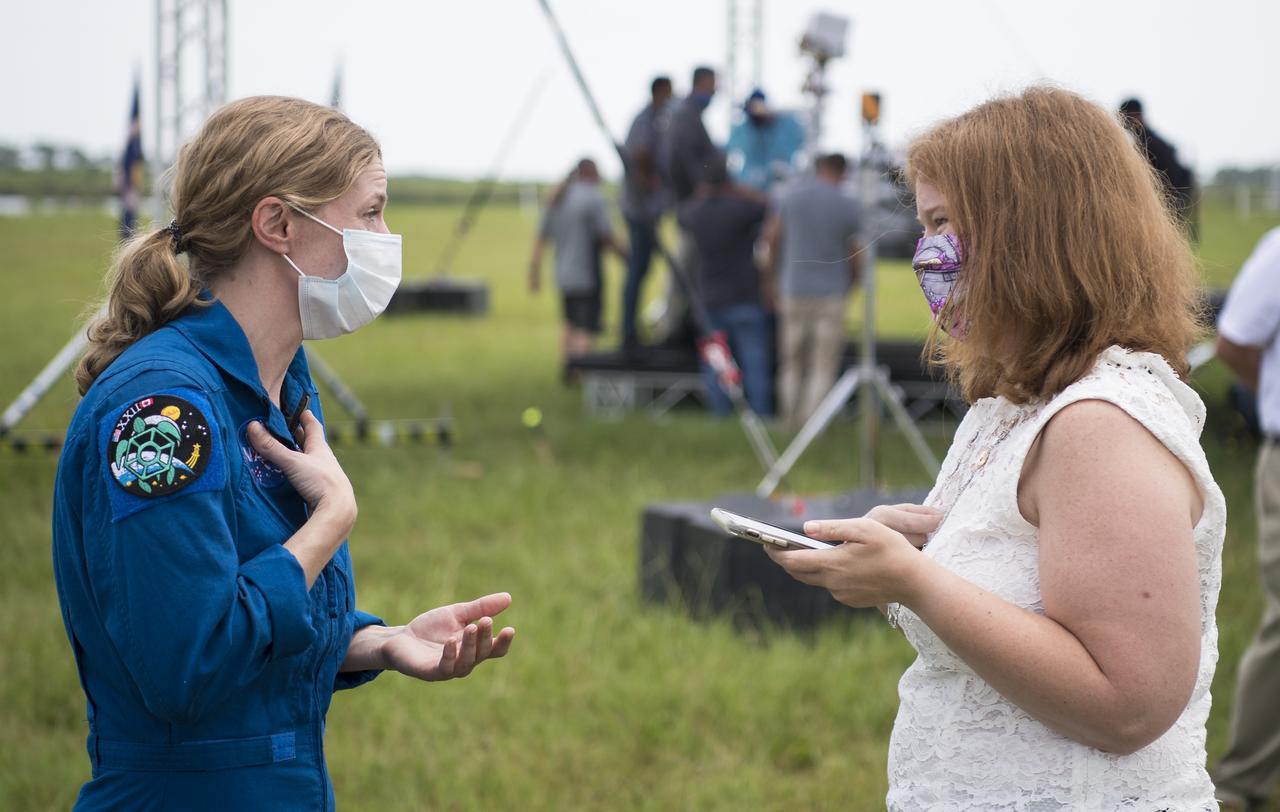NASA astronaut Zena Cardman speaks with a member of the media following a press conference ahead of the launch of NASA’s Mars 2020 Perseverance rover, Wednesday, July 29, 2020, at NASA’s Kennedy Space Center in Florida. The Perseverance rover is part of NASA’s Mars Exploration Program, a long-term effort of robotic exploration of the Red Planet. Launch is scheduled for Thursday, July 30.  Photo Credit: (NASA/Joel Kowsky)