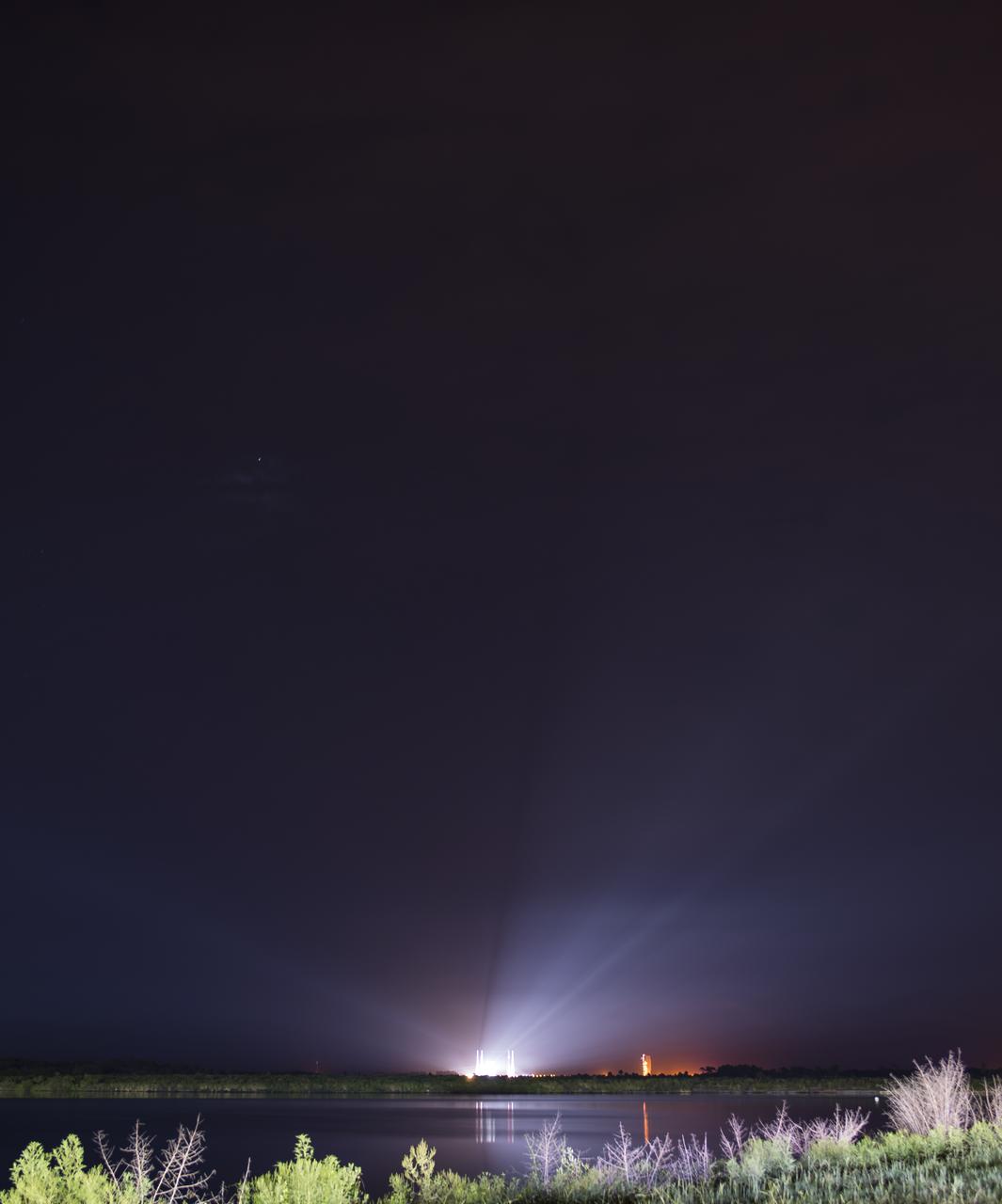 In this long exposure image, a United Launch Alliance Atlas V rocket with NASA’s Mars 2020 Perseverance rover onboard is seen illuminated by spotlights on the launch pad at Space Launch Complex 41 at Cape Canaveral Air Force Station, Thursday, July 30, 2020, from NASA’s Kennedy Space Center in Florida. The Perseverance rover is part of NASA’s Mars Exploration Program, a long-term effort of robotic exploration of the Red Planet. Launch is scheduled for Thursday, July 30. Photo Credit: (NASA/Joel Kowsky)