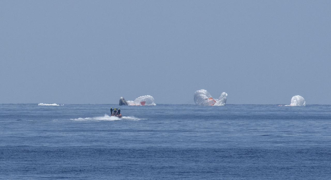 The SpaceX Crew Dragon Endeavour spacecraft is seen as it lands with NASA astronauts Robert Behnken and Douglas Hurley onboard in the Gulf of Mexico off the coast of Pensacola, Florida, Sunday, Aug. 2, 2020. The Demo-2 test flight for NASA's Commercial Crew Program was the first to deliver astronauts to the International Space Station and return them safely to Earth onboard a commercially built and operated spacecraft. Behnken and Hurley returned after spending 64 days in space. Photo Credit: (NASA/Bill Ingalls)