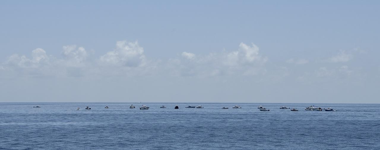 Support teams and curious recreational boaters arrive at the SpaceX Crew Dragon Endeavour spacecraft shortly after it landed with NASA astronauts Robert Behnken and Douglas Hurley onboard in the Gulf of Mexico off the coast of Pensacola, Florida, Sunday, Aug. 2, 2020. The Demo-2 test flight for NASA's Commercial Crew Program was the first to deliver astronauts to the International Space Station and return them safely to Earth onboard a commercially built and operated spacecraft. Behnken and Hurley returned after spending 64 days in space. Photo Credit: (NASA/Bill Ingalls)