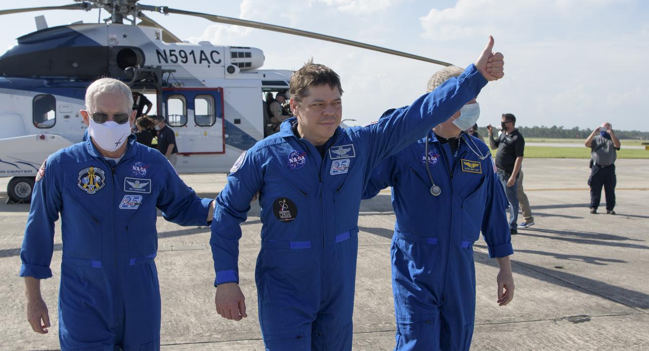 NASA astronaut Robert Behnken gives a thumbs up to onlookers as he boards a plane at Naval Air Station Pensacola to return him and NASA astronaut Douglas Hurley home to Houston a few hours after the duo landed in their SpaceX Crew Dragon Endeavour spacecraft off the coast of Pensacola, Florida, Sunday, Aug. 2, 2020. The Demo-2 test flight for NASA's Commercial Crew Program was the first to deliver astronauts to the International Space Station and return them safely to Earth onboard a commercially built and operated spacecraft. Behnken and Hurley returned after spending 64 days in space. Photo Credit: (NASA/Bill Ingalls)