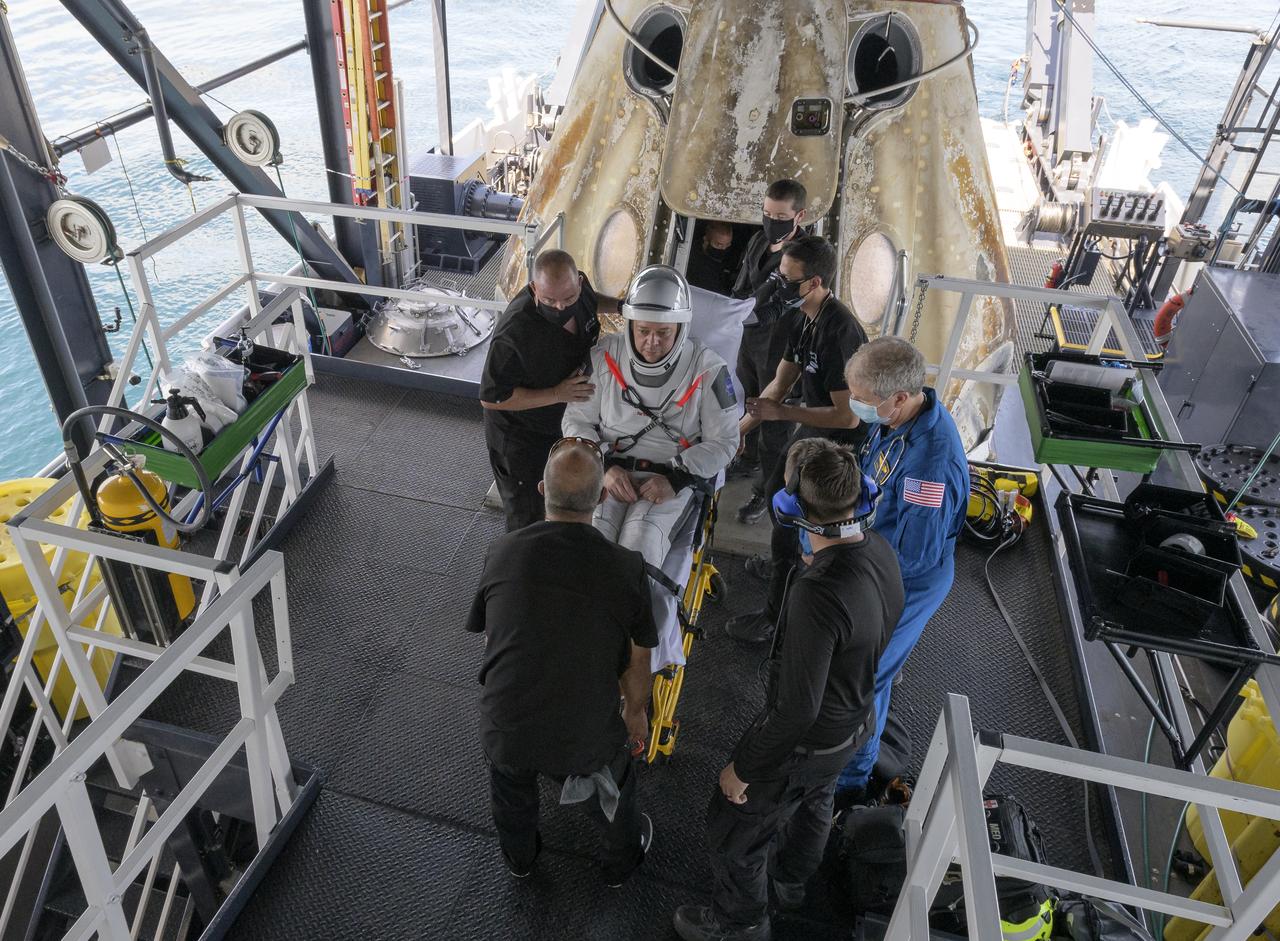 NASA astronaut Robert Behnken is helped out of the SpaceX Crew Dragon Endeavour spacecraft onboard the SpaceX GO Navigator recovery ship after he and NASA astronaut Douglas Hurley landed in the Gulf of Mexico off the coast of Pensacola, Florida, Sunday, Aug. 2, 2020. The Demo-2 test flight for NASA's Commercial Crew Program was the first to deliver astronauts to the International Space Station and return them safely to Earth onboard a commercially built and operated spacecraft. Behnken and Hurley returned after spending 64 days in space. Photo Credit: (NASA/Bill Ingalls)