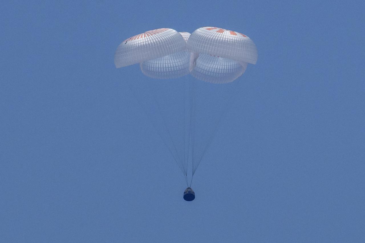 The SpaceX Crew Dragon Endeavour spacecraft is seen as it lands with NASA astronauts Robert Behnken and Douglas Hurley onboard in the Gulf of Mexico off the coast of Pensacola, Florida, Sunday, Aug. 2, 2020. The Demo-2 test flight for NASA's Commercial Crew Program was the first to deliver astronauts to the International Space Station and return them safely to Earth onboard a commercially built and operated spacecraft. Behnken and Hurley returned after spending 64 days in space. Photo Credit: (NASA/Bill Ingalls)
