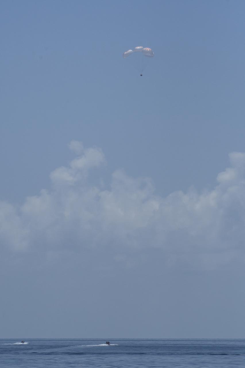 The SpaceX Crew Dragon Endeavour spacecraft is seen as it lands with NASA astronauts Robert Behnken and Douglas Hurley onboard in the Gulf of Mexico off the coast of Pensacola, Florida, Sunday, Aug. 2, 2020. The Demo-2 test flight for NASA's Commercial Crew Program was the first to deliver astronauts to the International Space Station and return them safely to Earth onboard a commercially built and operated spacecraft. Behnken and Hurley returned after spending 64 days in space. Photo Credit: (NASA/Bill Ingalls)