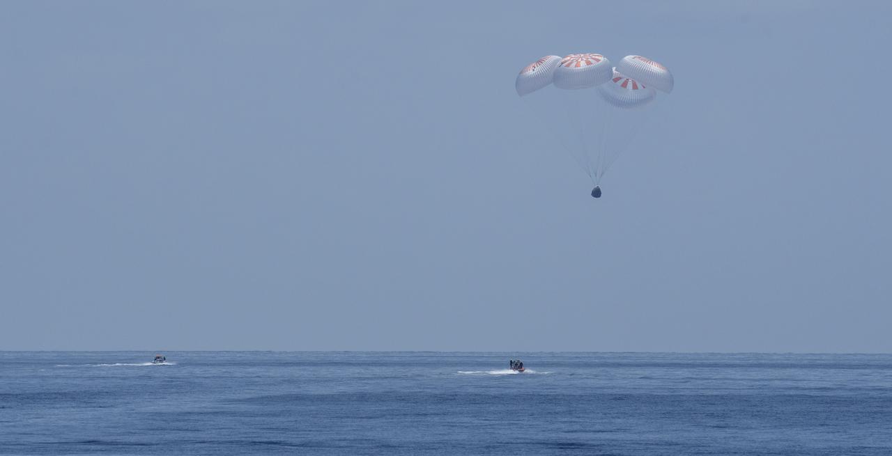 The SpaceX Crew Dragon Endeavour spacecraft is seen as it lands with NASA astronauts Robert Behnken and Douglas Hurley onboard in the Gulf of Mexico off the coast of Pensacola, Florida, Sunday, Aug. 2, 2020. The Demo-2 test flight for NASA's Commercial Crew Program was the first to deliver astronauts to the International Space Station and return them safely to Earth onboard a commercially built and operated spacecraft. Behnken and Hurley returned after spending 64 days in space. Photo Credit: (NASA/Bill Ingalls)