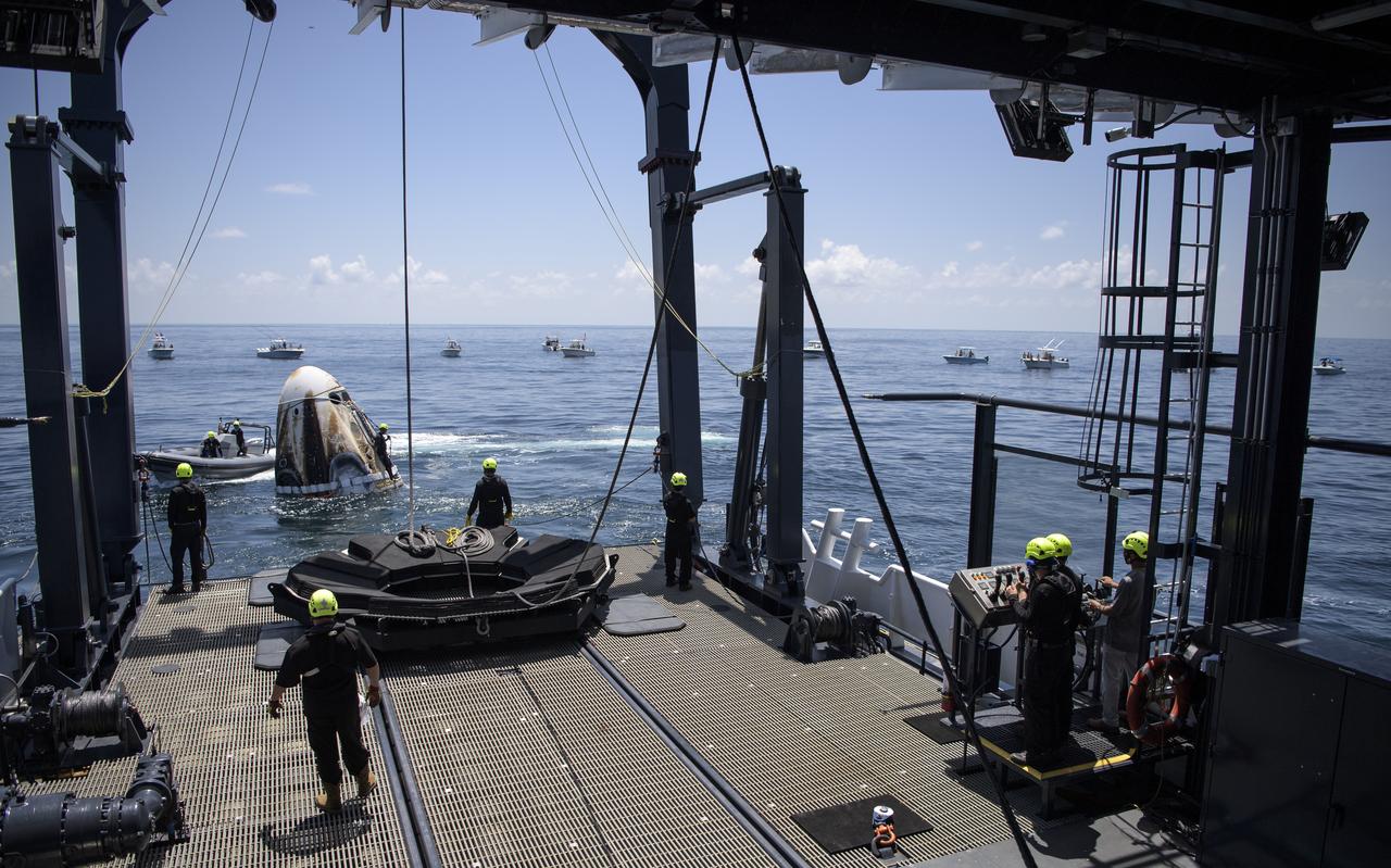 Support teams arrive at the SpaceX Crew Dragon Endeavour spacecraft shortly after it landed with NASA astronauts Robert Behnken and Douglas Hurley onboard in the Gulf of Mexico off the coast of Pensacola, Florida, Sunday, Aug. 2, 2020. The Demo-2 test flight for NASA's Commercial Crew Program was the first to deliver astronauts to the International Space Station and return them safely to Earth onboard a commercially built and operated spacecraft. Behnken and Hurley returned after spending 64 days in space. Photo Credit: (NASA/Bill Ingalls)