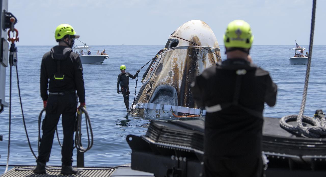 Support teams arrive at the SpaceX Crew Dragon Endeavour spacecraft shortly after it landed with NASA astronauts Robert Behnken and Douglas Hurley onboard in the Gulf of Mexico off the coast of Pensacola, Florida, Sunday, Aug. 2, 2020. The Demo-2 test flight for NASA's Commercial Crew Program was the first to deliver astronauts to the International Space Station and return them safely to Earth onboard a commercially built and operated spacecraft. Behnken and Hurley returned after spending 64 days in space. Photo Credit: (NASA/Bill Ingalls)