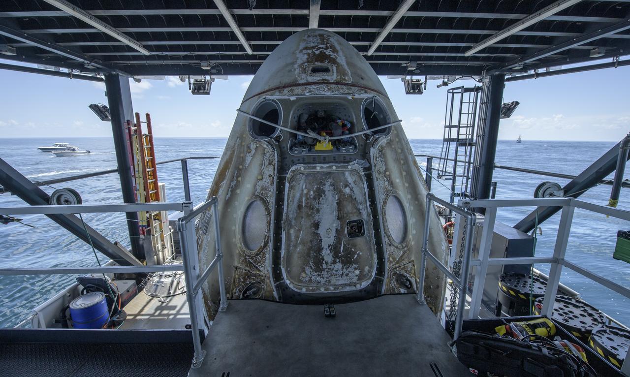 The SpaceX Crew Dragon Endeavour spacecraft, with NASA astronauts Robert Behnken and Douglas Hurley onboard, is positioned on the SpaceX GO Navigator recovery ship for crew egress shortly after landing in the Gulf of Mexico off the coast of Pensacola, Florida, Sunday, Aug. 2, 2020. The Demo-2 test flight for NASA's Commercial Crew Program was the first to deliver astronauts to the International Space Station and return them safely to Earth onboard a commercially built and operated spacecraft. Behnken and Hurley returned after spending 64 days in space. Photo Credit: (NASA/Bill Ingalls)