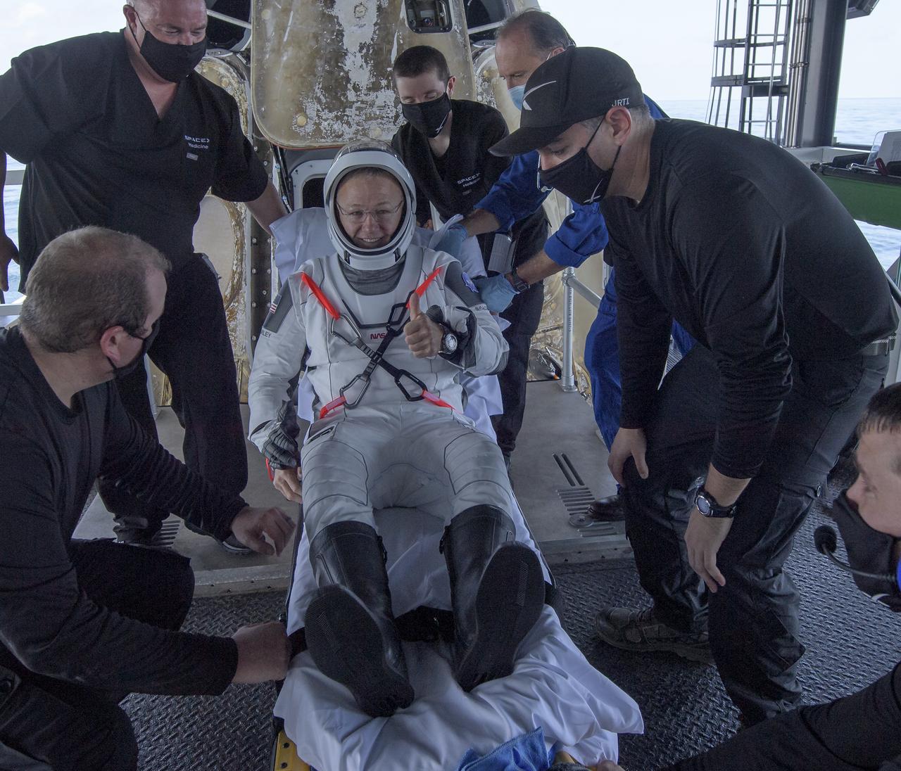 NASA astronaut Douglas Hurley is helped out of the SpaceX Crew Dragon Endeavour spacecraft onboard the SpaceX GO Navigator recovery ship after he and NASA astronaut Robert Behnken landed in the Gulf of Mexico off the coast of Pensacola, Florida, Sunday, Aug. 2, 2020. The Demo-2 test flight for NASA's Commercial Crew Program was the first to deliver astronauts to the International Space Station and return them safely to Earth onboard a commercially built and operated spacecraft. Behnken and Hurley returned after spending 64 days in space. Photo Credit: (NASA/Bill Ingalls)