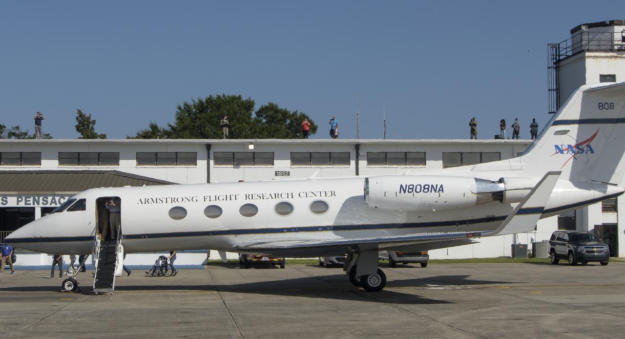 Well wishers gather on the roof of Naval Air Station Pensacola Sherman Field to catch a glimpse of NASA astronauts Robert Behnken and Douglas Hurley before they board a plane to return home to Houston a few hours after the duo landed in their SpaceX Crew Dragon Endeavour spacecraft off the coast of Pensacola, Florida, Sunday, Aug. 2, 2020. The Demo-2 test flight for NASA's Commercial Crew Program was the first to deliver astronauts to the International Space Station and return them safely to Earth onboard a commercially built and operated spacecraft. Behnken and Hurley returned after spending 64 days in space. Photo Credit: (NASA/Bill Ingalls)
