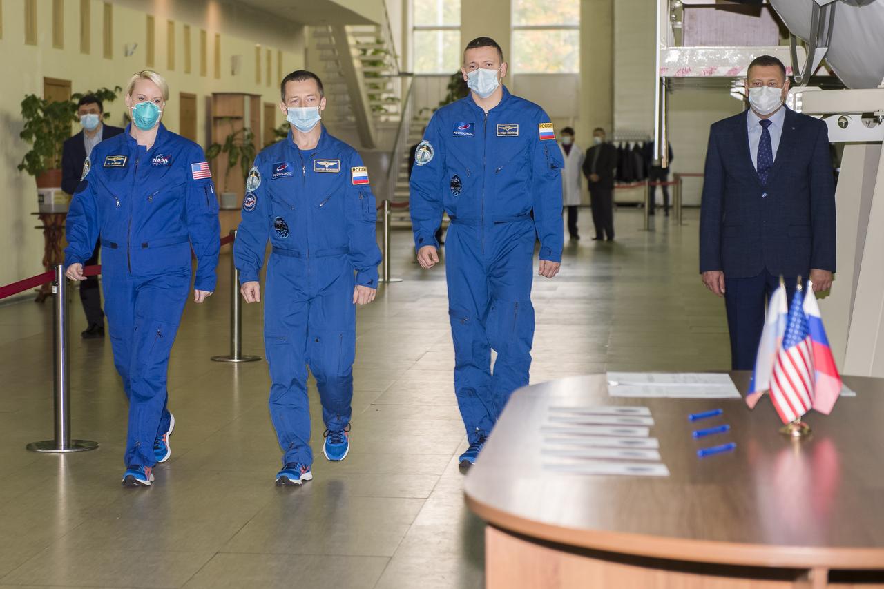 Expedition 64 crew members NASA astronaut Kate Rubins, left, Russian cosmonaut Sergey Ryzhikov of Roscosmos, center, and Russian cosmonaut Sergey Kud-Sverchkov of Roscosmos arrive for Soyuz qualification exams Tuesday, Sept. 22, 2020 at the Gagarin Cosmonaut Training Center (GCTC) in Star City, Russia, in advance of their scheduled launch October 14 from Baikonur Cosmodrome in Kazakhstan to the International Space Station. Photo Credit: (NASA/GCTC/Irina Spector)