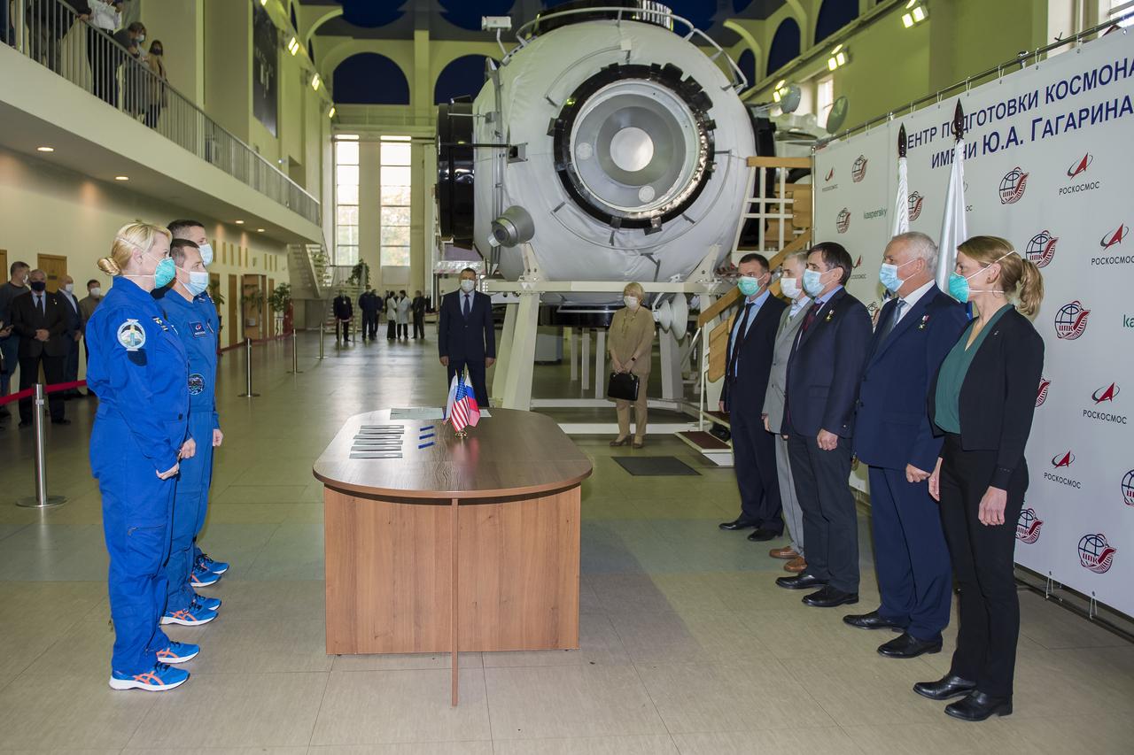 Expedition 64 crew members NASA astronaut Kate Rubins, left, Russian cosmonaut Sergey Ryzhikov of Roscosmos, center, and Russian cosmonaut Sergey Kud-Sverchkov of Roscosmos meet with mission managers ahead of their Soyuz qualification exams, Tuesday, Sept. 22, 2020 at the Gagarin Cosmonaut Training Center (GCTC) in Star City, Russia. Photo Credit: (NASA/GCTC/Irina Spector)