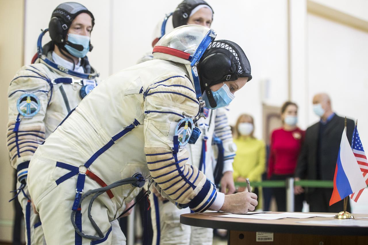 Expedition 64 crew member NASA astronaut Kate Rubins signs in for Soyuz qualification exams as crew mates Sergey Ryzhikov of Roscosmos, center, and Russian cosmonaut Sergey Kud-Sverchkov of Roscosmos look on, Wednesday, Sept. 23, 2020 at the Gagarin Cosmonaut Training Center (GCTC) in Star City, Russia. Photo Credit: (NASA/GCTC/Andrey Shelepin)