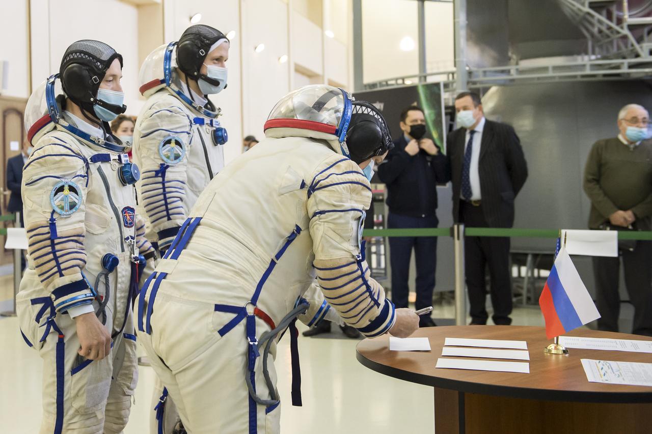 Expedition 64 crew member Kate Rubins of NASA signs in for Soyuz qualification exams as crew mates Sergey Ryzhikov of Roscosmos, center, and Sergey Kud-Sverchkov of Roscosmos look on, Wednesday, Sept. 23, 2020 at the Gagarin Cosmonaut Training Center (GCTC) in Star City, Russia. Photo Credit: (NASA/GCTC/Irina Spector)