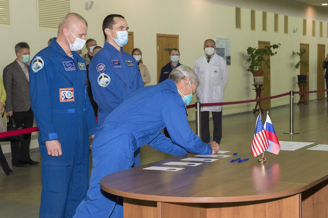 Expedition 64 backup crew member Mark Vande Hei of NASA signs in for his Soyuz qualification exams as crew mates Oleg Novitskiy of Roscosmos, left, and Petr Dubrov of Roscosmos look on, Wednesday, Sept. 23, 2020 at the Gagarin Cosmonaut Training Center (GCTC) in Star City, Russia. Photo Credit: (NASA/GCTC/Irina Spector)