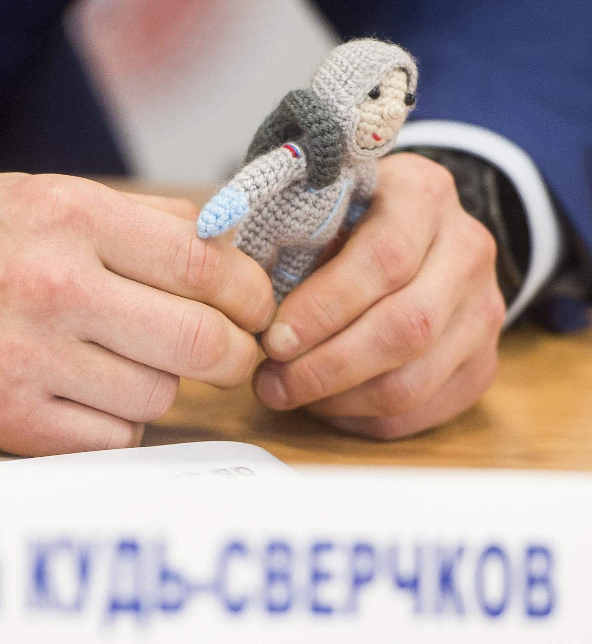 Expedition 64 prime crew member Sergey Kud-Sverchkov of Roscosmos holds a knit cosmonaut named Yuri made by his wife Olga, during a press conference prior to his launch from the Baikonur Cosmodrome in Kazakhstan, Thursday, Sept. 24, 2020 at the Gagarin Cosmonaut Training Center (GCTC) in Star City, Russia. Photo Credit: (NASA/GCTC/Andrey Shelepin)