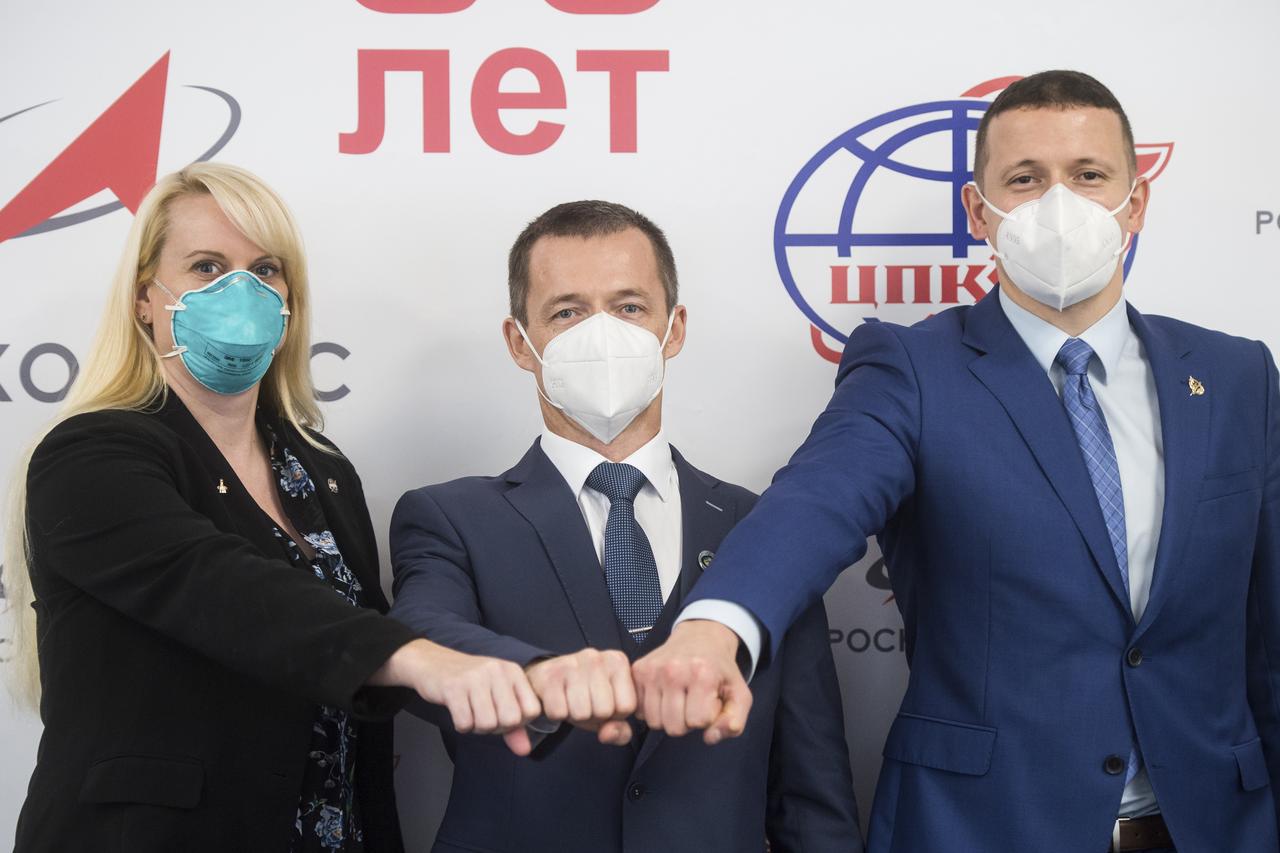 From left to right, Expedition 64 prime crew members, NASA astronaut Kate Rubins, Russian cosmonaut Sergey Ryzhikov of Roscosmos, and Russian cosmonaut Sergey Kud-Sverchkov of Roscosmos, pose for a photo at the conclusion of a press conference prior to their scheduled launch October 14 from the Baikonur Cosmodrome in Kazakhstan, Thursday, Sept. 24, 2020 at the Gagarin Cosmonaut Training Center (GCTC) in Star City, Russia. Photo Credit: (NASA/GCTC/Andrey Shelepin)